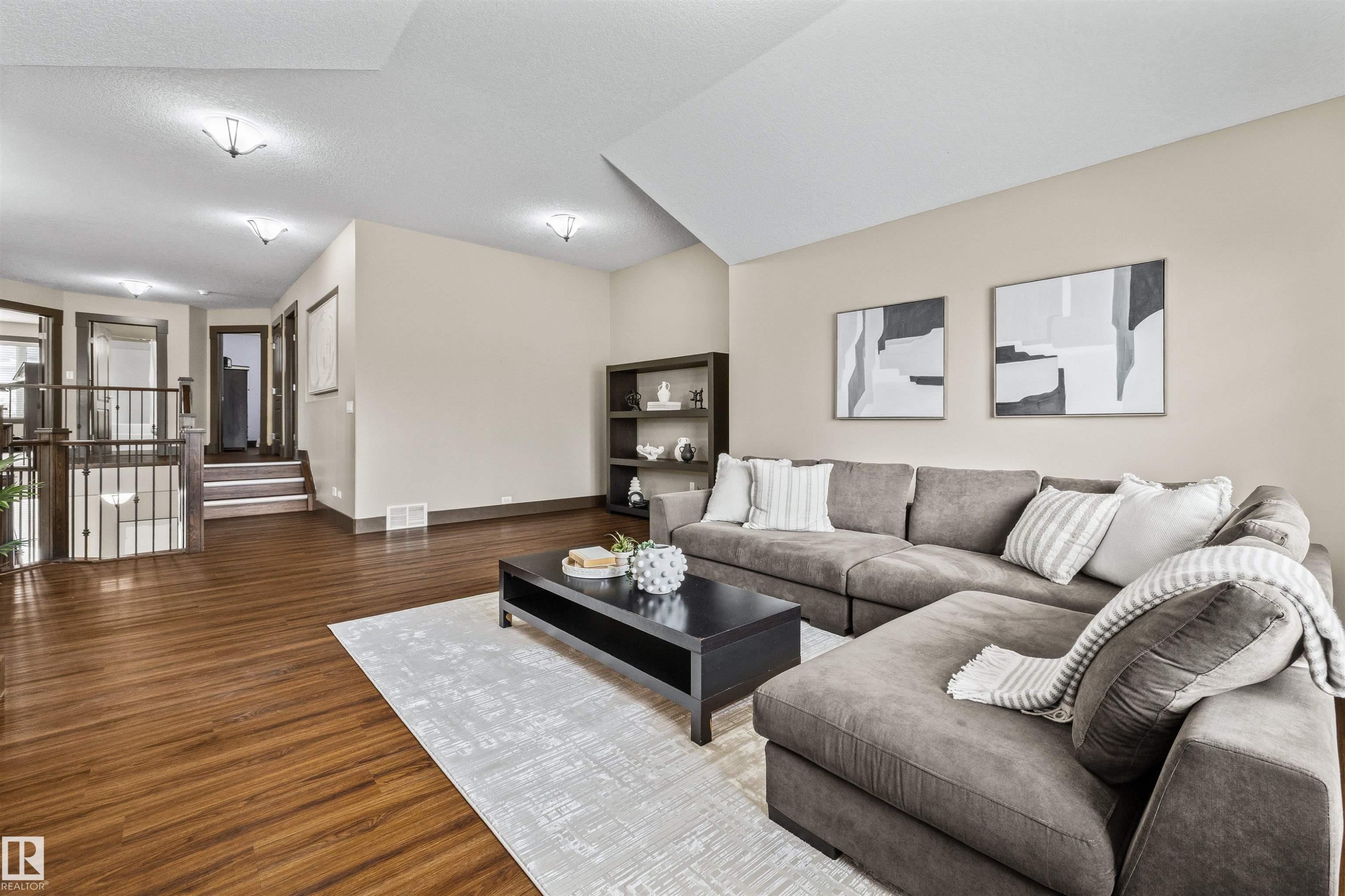 Family Room featuring hardwood flooring, a vaulted ceiling, and recessed lighting - 1014 Hope Road, Edmonton, AB - Indoor Photo Showing Living Room