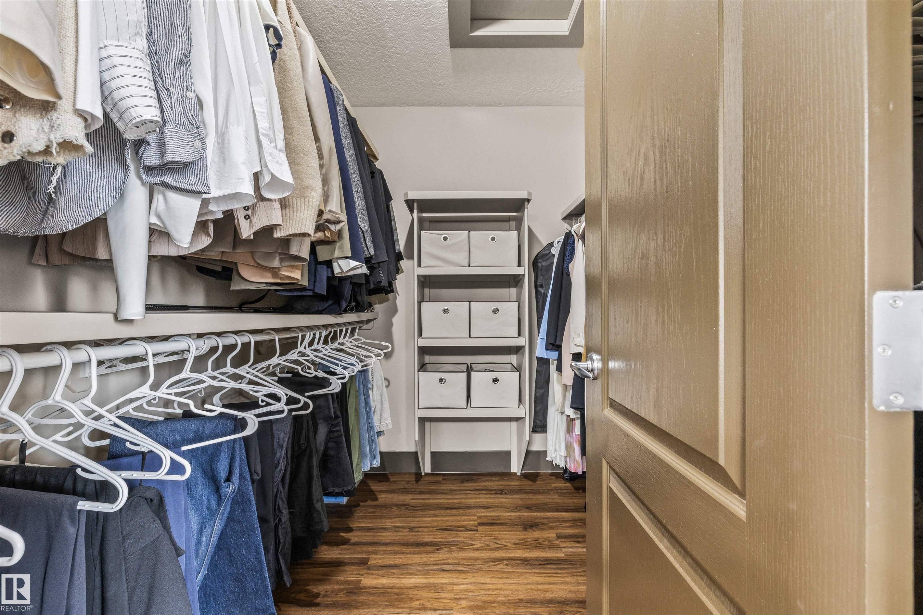 The property features a walk-in closet with wood-look flooring and built-in shelving - 1014 Hope Road, Edmonton, AB - Indoor