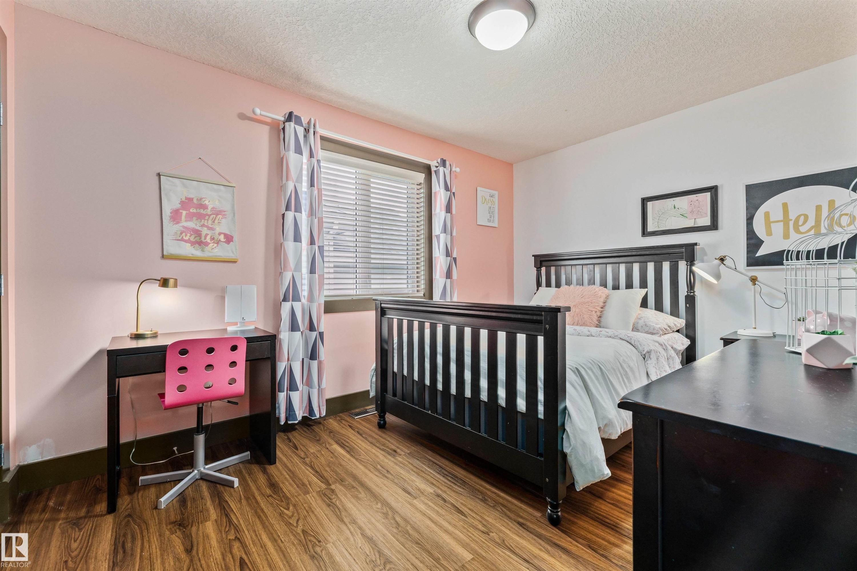 This room features wood-look flooring, a window with blinds and patterned curtains, and a ceiling light fixture - 1014 Hope Road, Edmonton, AB - Indoor Photo Showing Bedroom