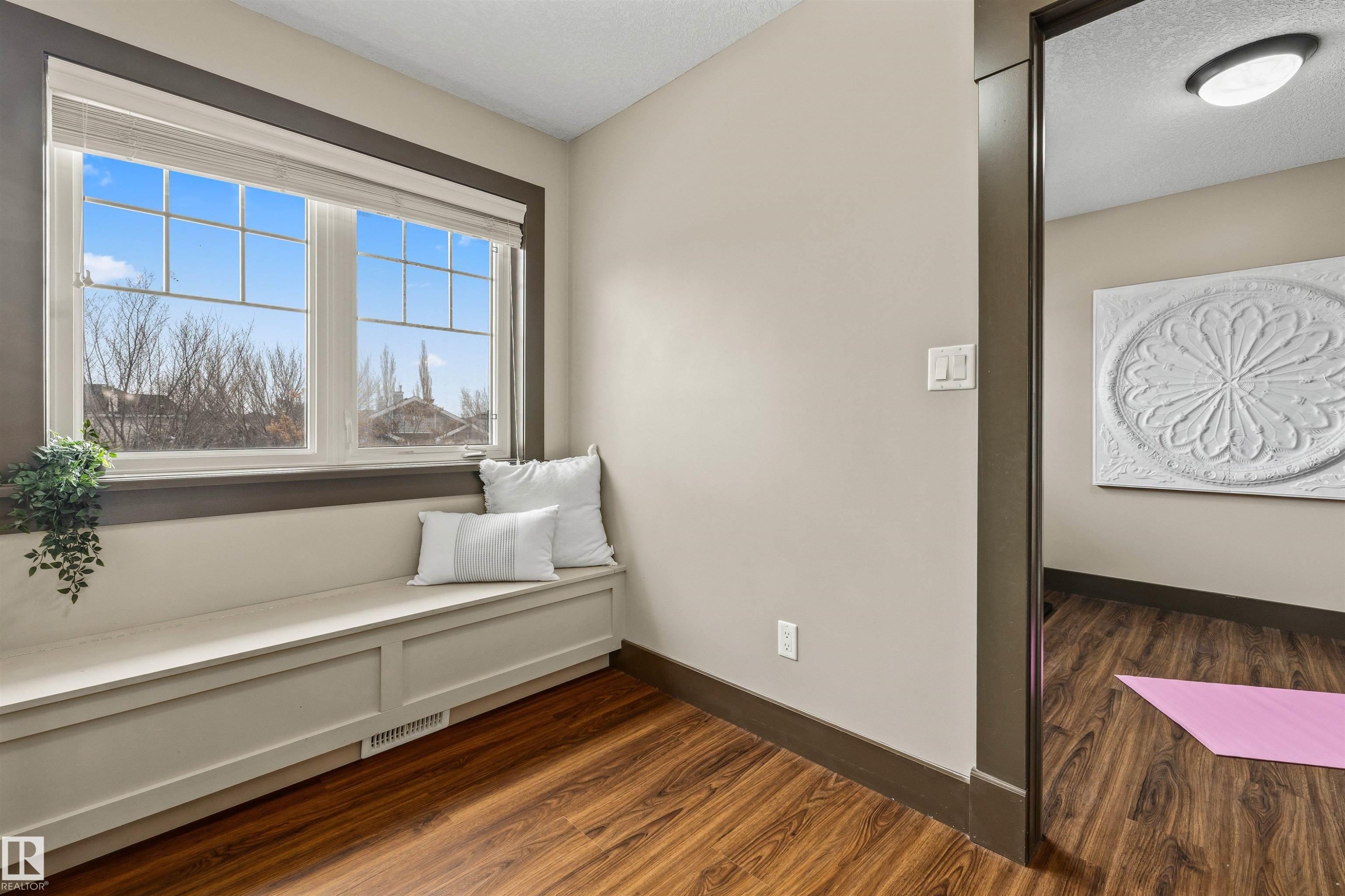 This room features wood flooring, a built-in window bench, and large windows with blinds - 1014 Hope Road, Edmonton, AB - Indoor Photo Showing Other Room