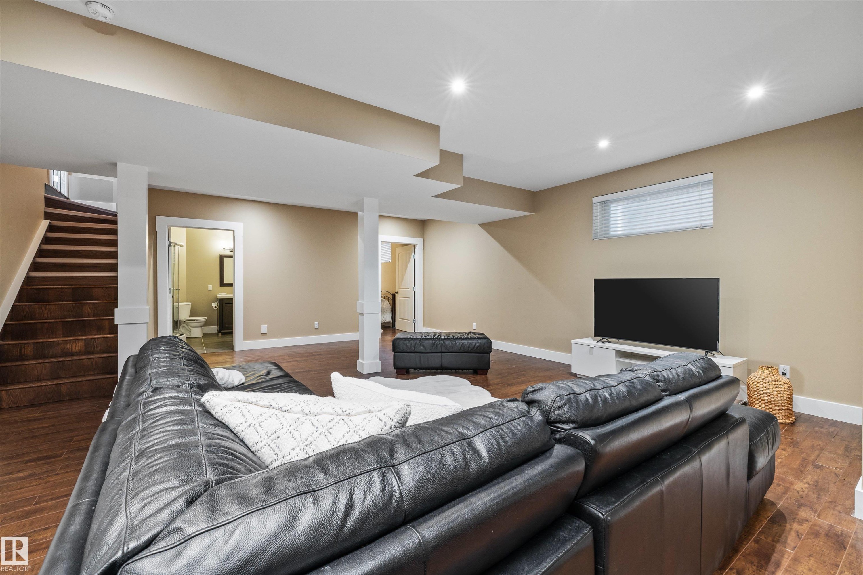 Inviting second living space featuring recessed lighting, a window with blinds, and rich wood flooring - 1014 Hope Road, Edmonton, AB - Indoor Photo Showing Basement