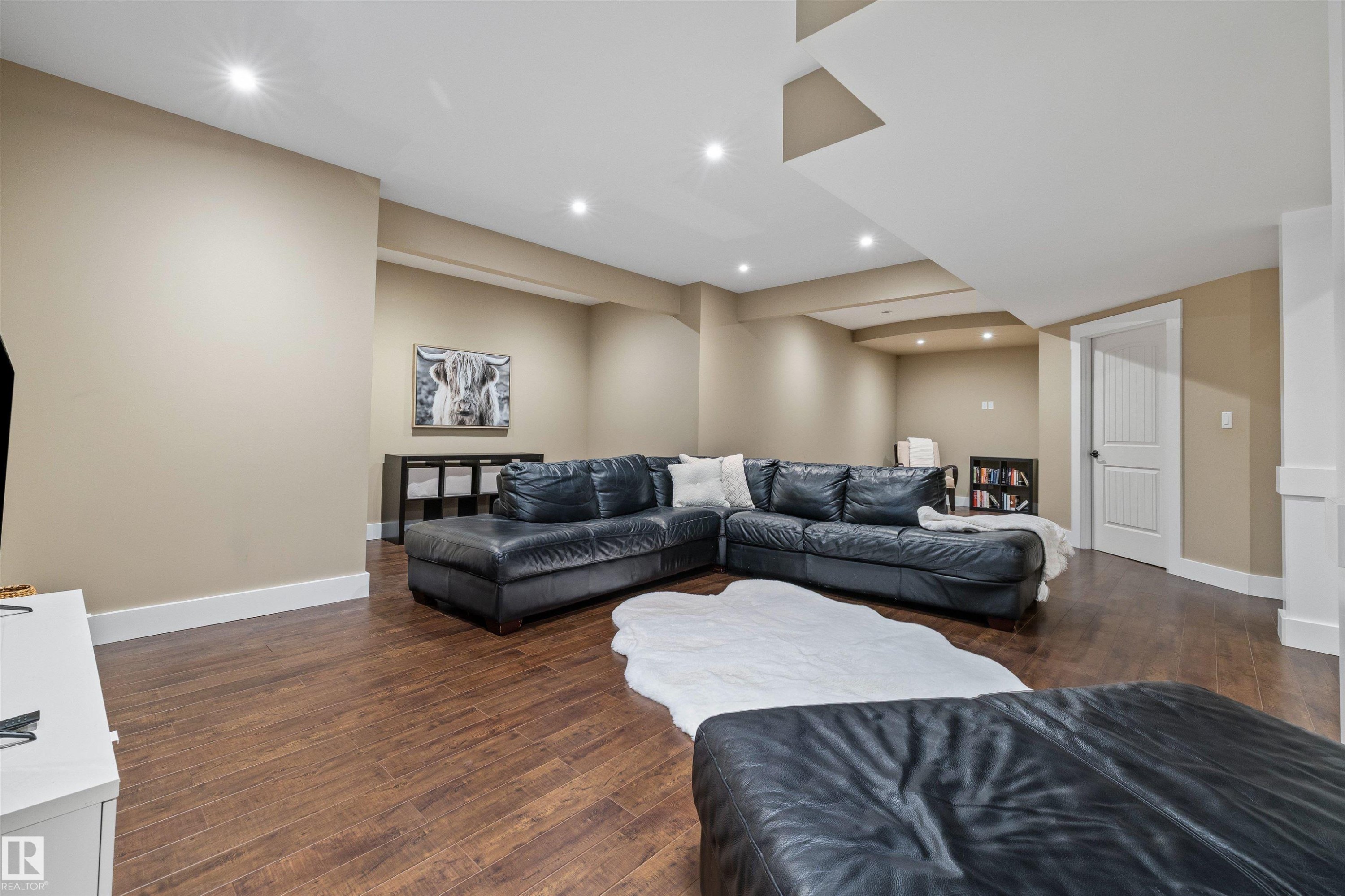 This second living area features hardwood floors, recessed lighting, and a neutral color palette - 1014 Hope Road, Edmonton, AB - Indoor Photo Showing Other Room