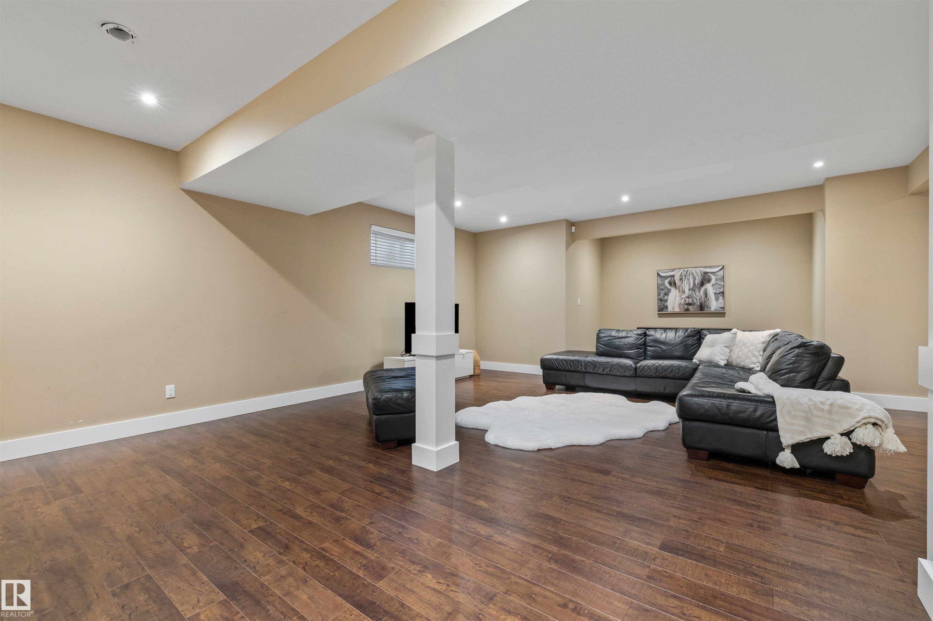 This spacious second living area features recessed lighting, durable wood flooring, and a window with blinds - 1014 Hope Road, Edmonton, AB - Indoor Photo Showing Basement