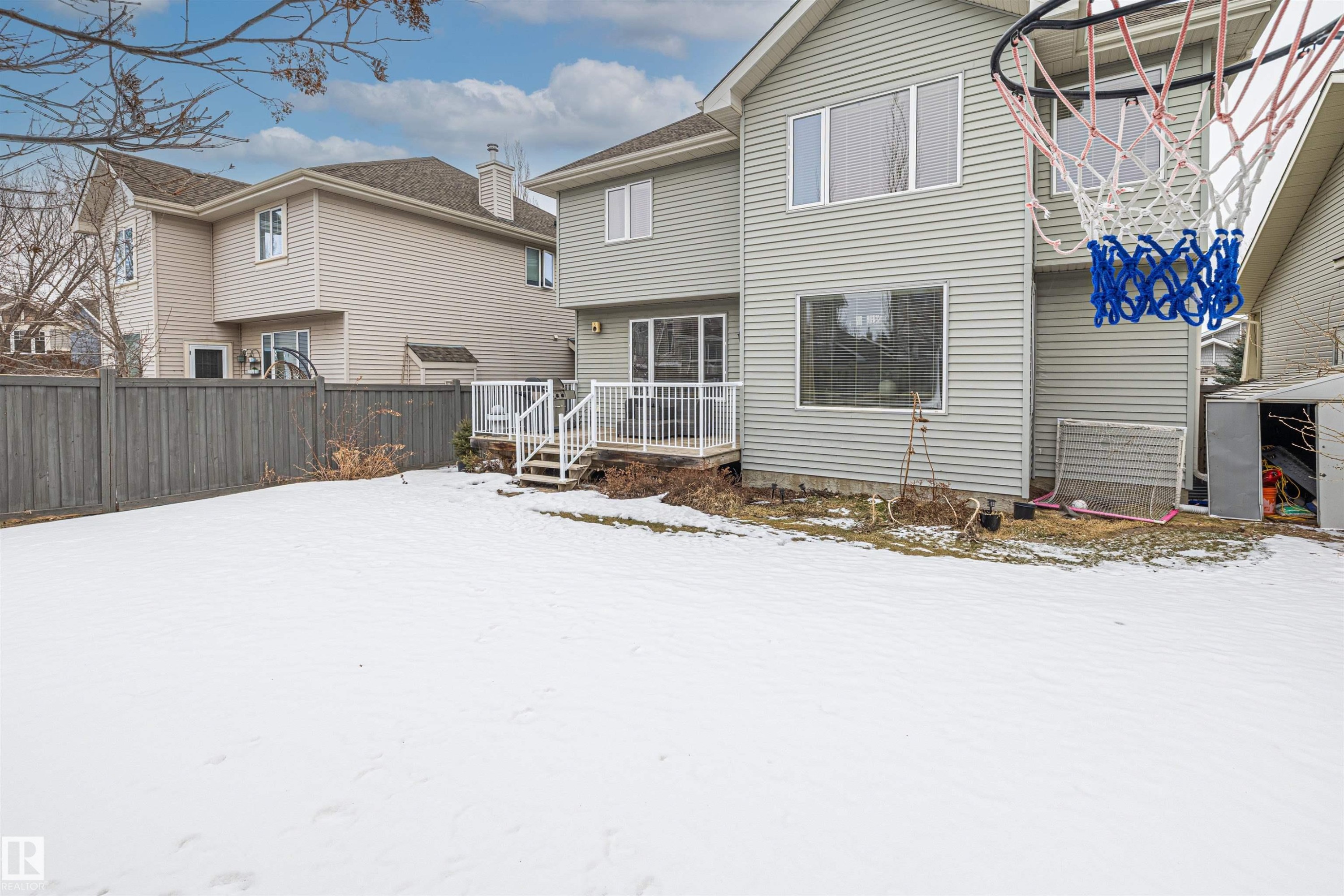 The property features a fenced yard, a rear deck with white railings, and an exterior with siding - 1014 Hope Road, Edmonton, AB - Outdoor