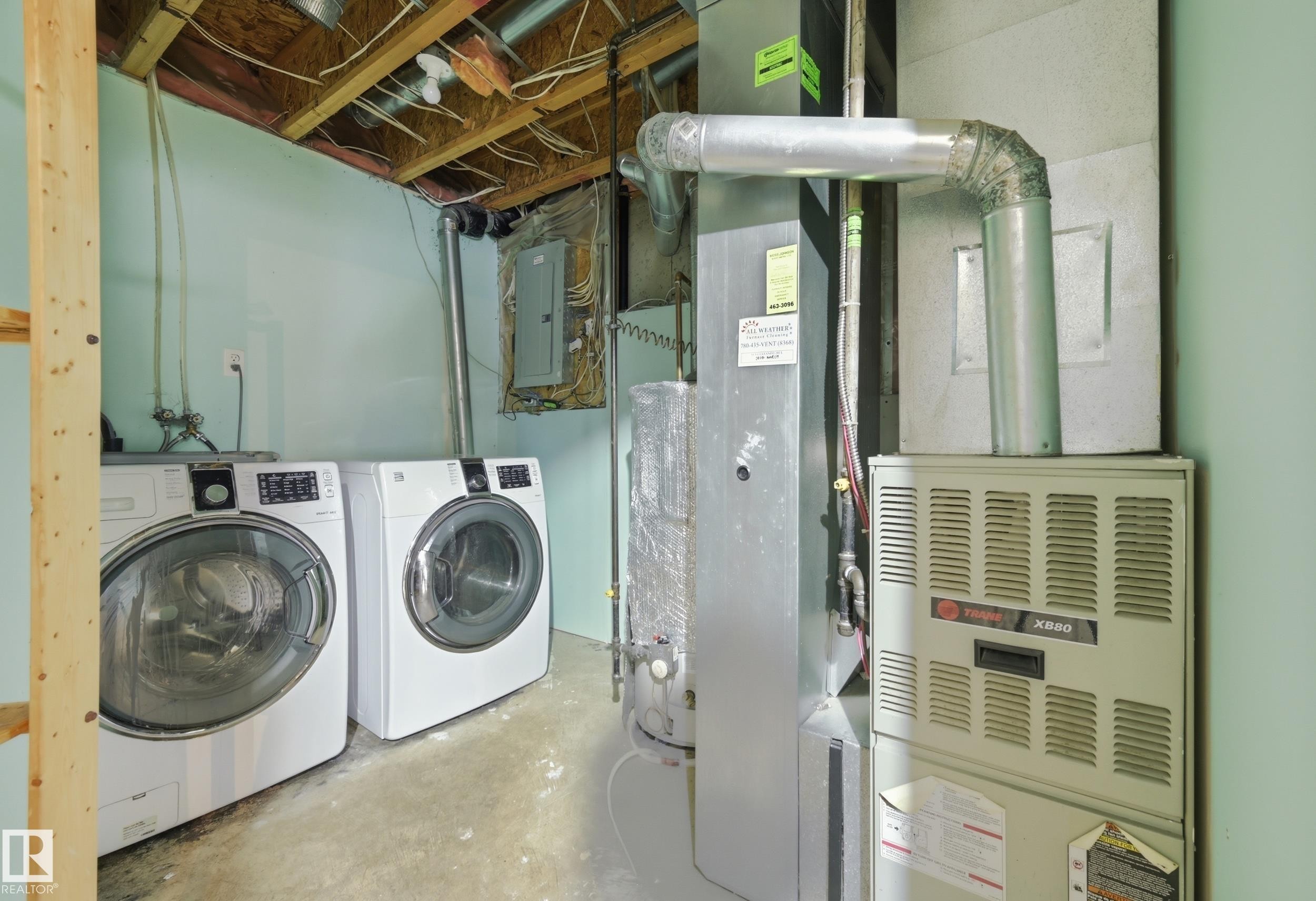 Utility area featuring a washer and dryer, a water heater, and a furnace - 53 287 Macewan Road, Edmonton, AB - Indoor Photo Showing Laundry Room