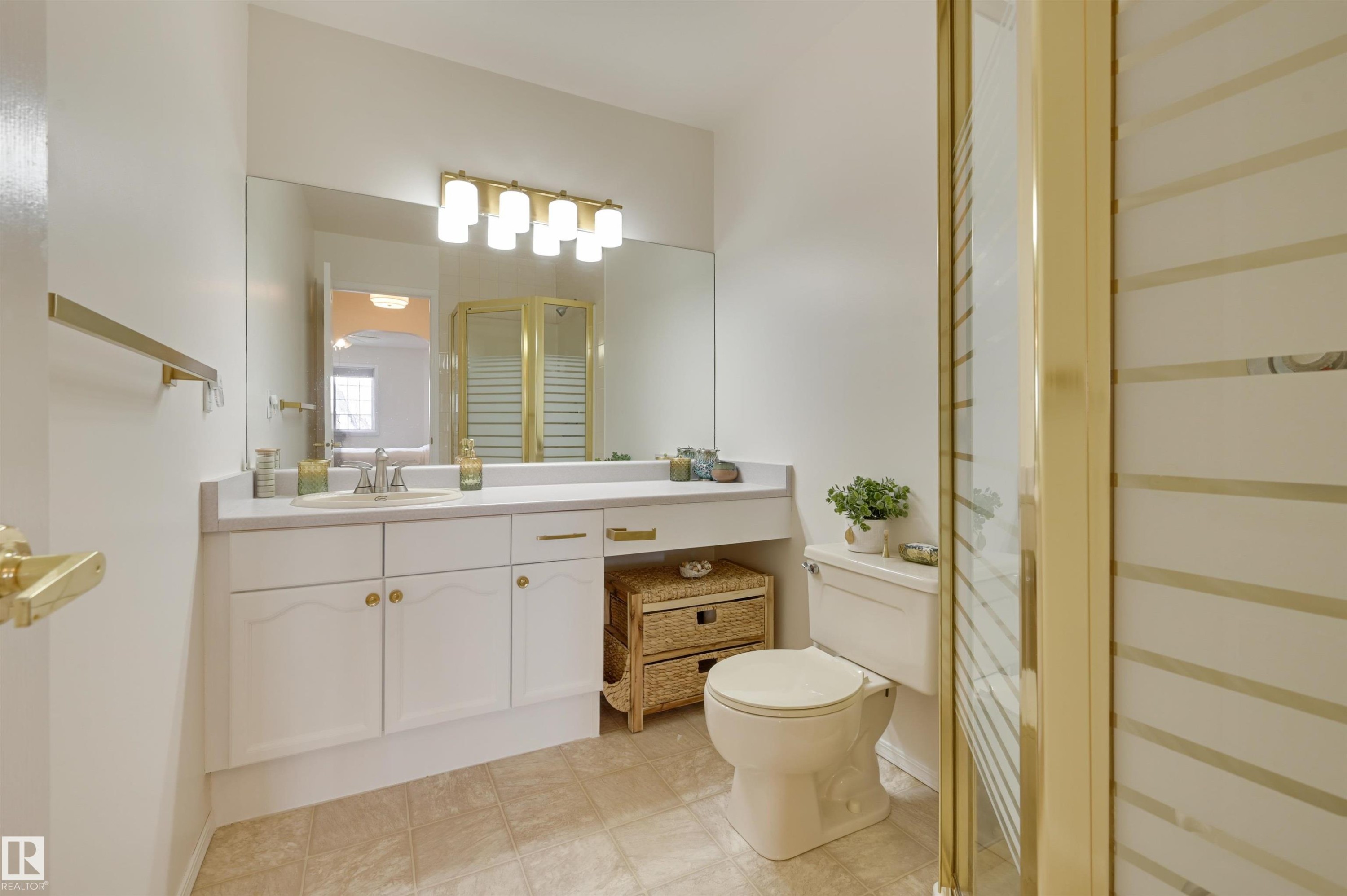 Bathroom featuring a vanity with a sink, a mirror, and a toilet - 304 17151 94A Avenue, Edmonton, AB - Indoor Photo Showing Bathroom
