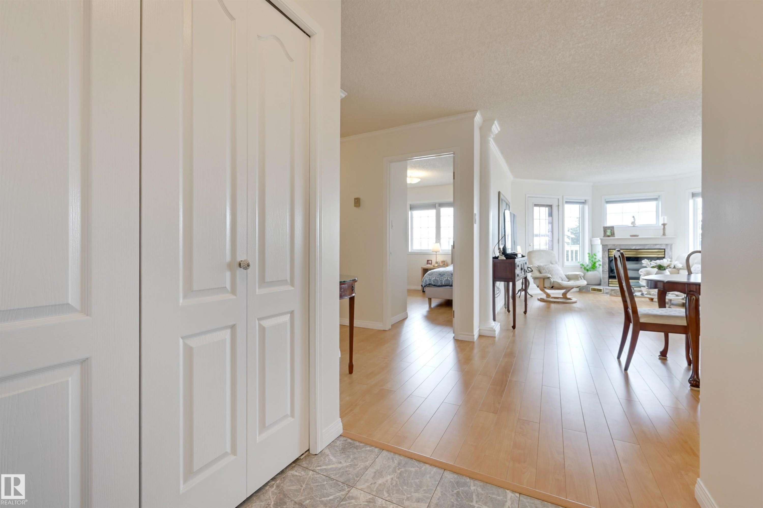 The property features light-toned wood flooring throughout the living areas, complemented by white walls and trim - 304 17151 94A Avenue, Edmonton, AB - Indoor Photo Showing Other Room