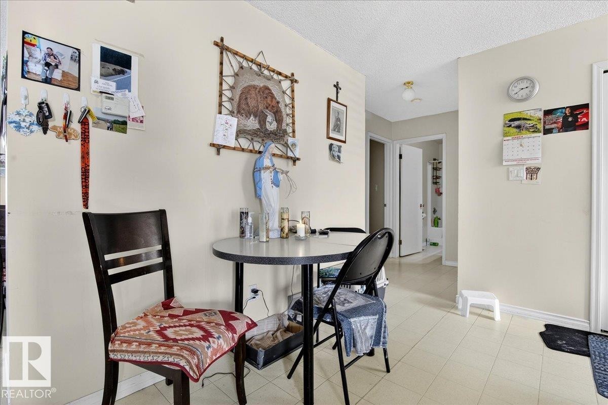 This area features light-colored walls and a tiled floor - 13304 130 Avenue, Edmonton, AB - Indoor Photo Showing Dining Room