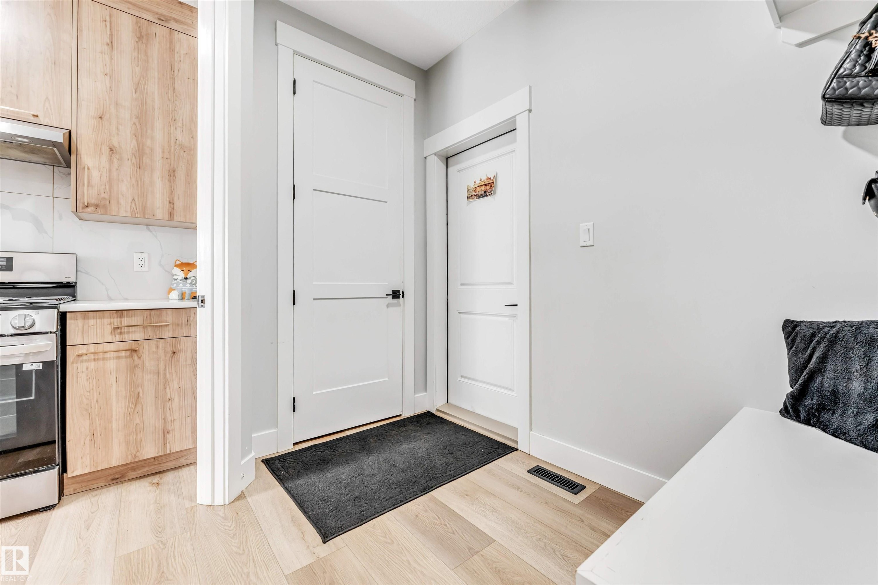 The property features light wood flooring, white walls, and white interior doors - 1531 151 Avenue, Edmonton, AB - Indoor