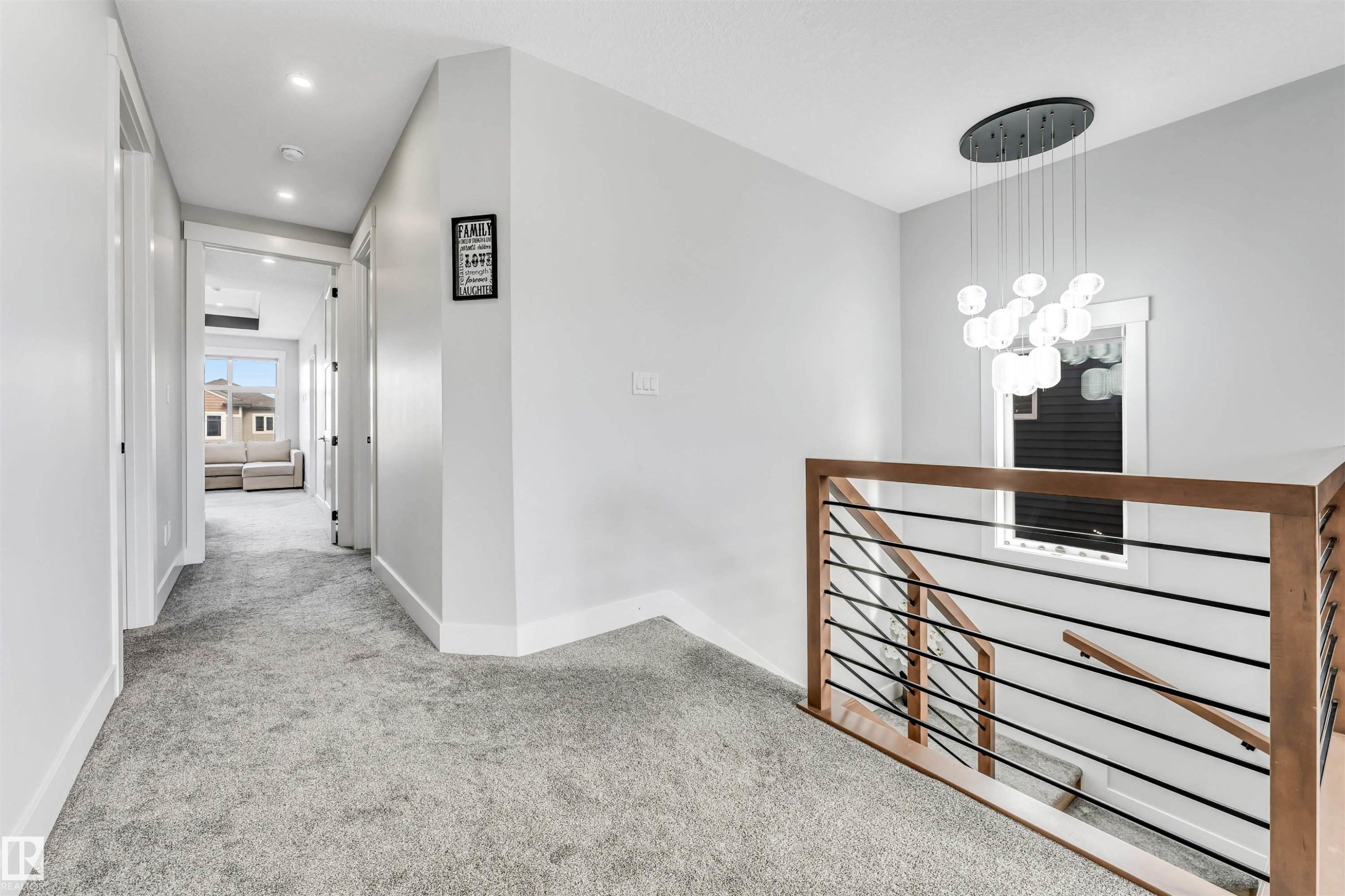 This property features a contemporary hallway with light grey carpeting, recessed lighting, and white walls - 1531 151 Avenue, Edmonton, AB - Indoor Photo Showing Other Room