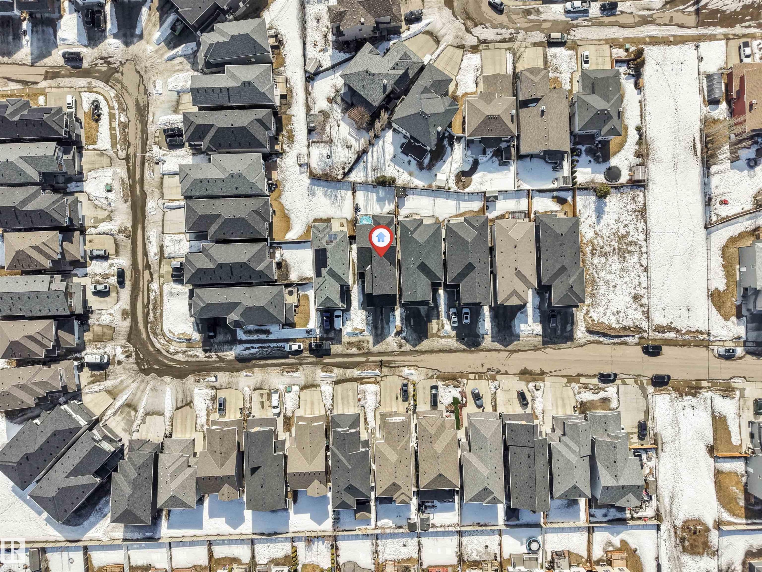 Aerial view of the property and its surrounding neighborhood, featuring residential streets and homes with dark-colored roofs - 1531 151 Avenue, Edmonton, AB - With View