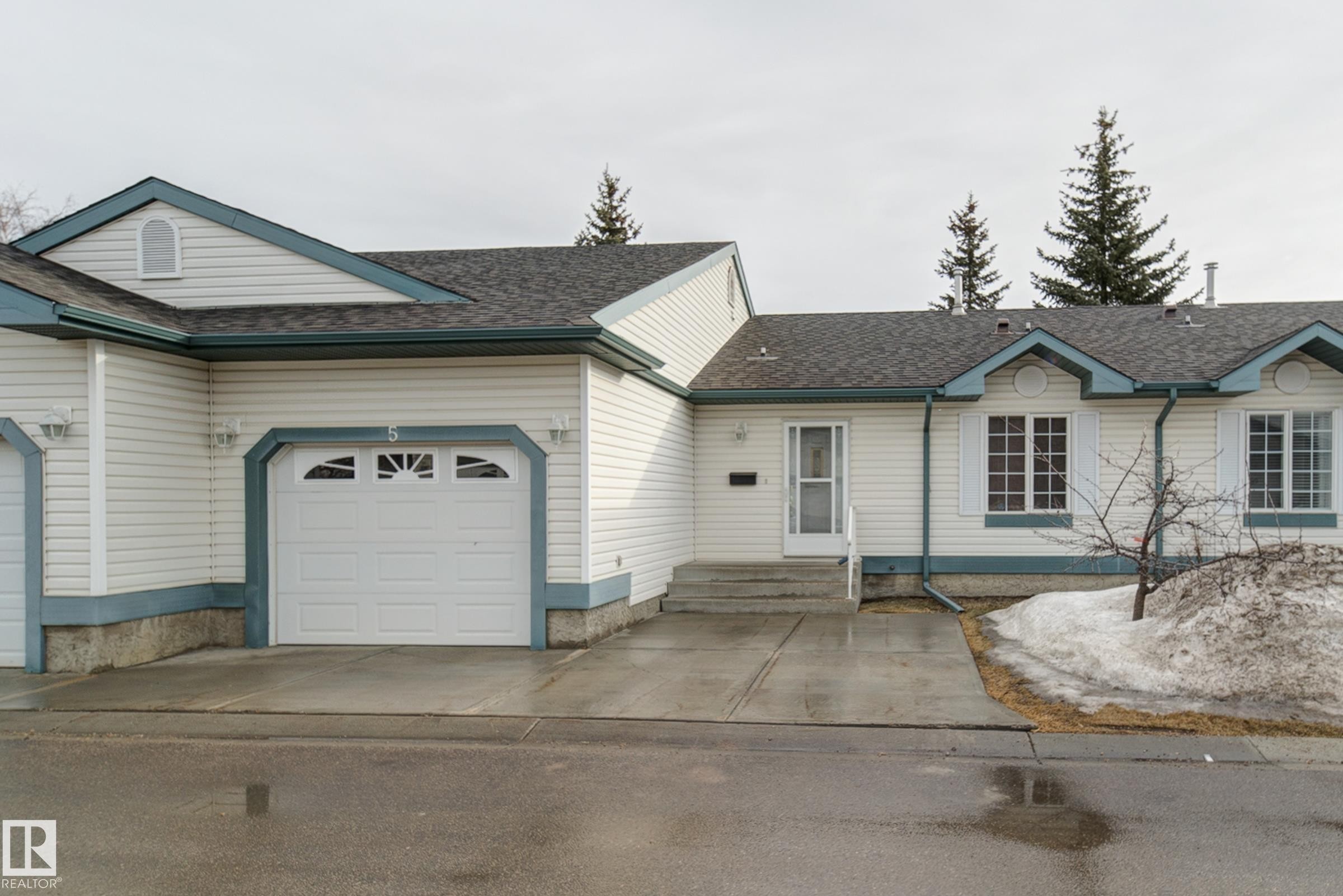 The property features a private garage with a driveway, white siding, and a gabled roof - 5 308 Jackson Road, Edmonton, AB - Outdoor