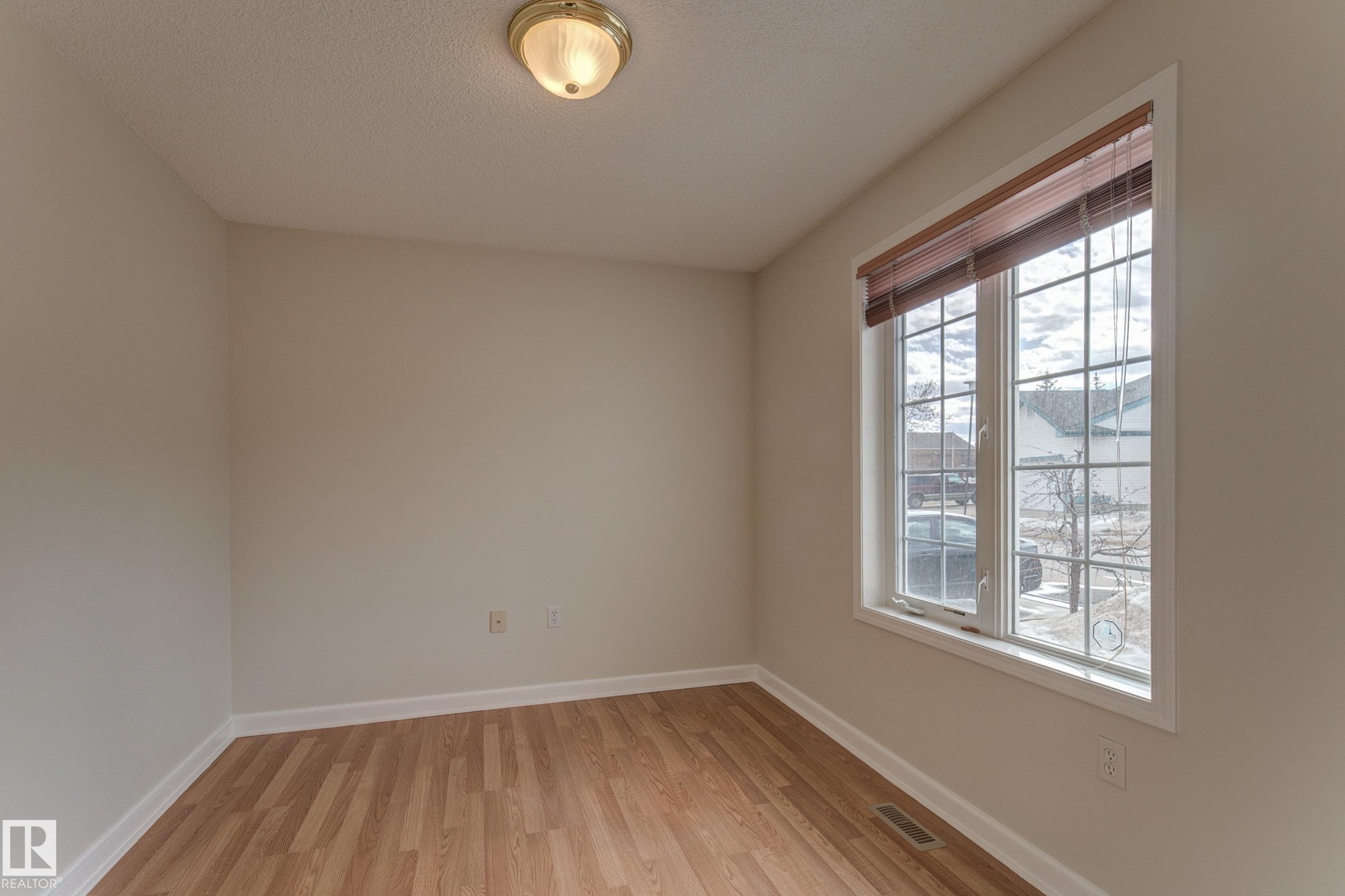This room features neutral wall tones, and a window with blinds, allowing for natural light - 5 308 Jackson Road, Edmonton, AB - Indoor Photo Showing Other Room