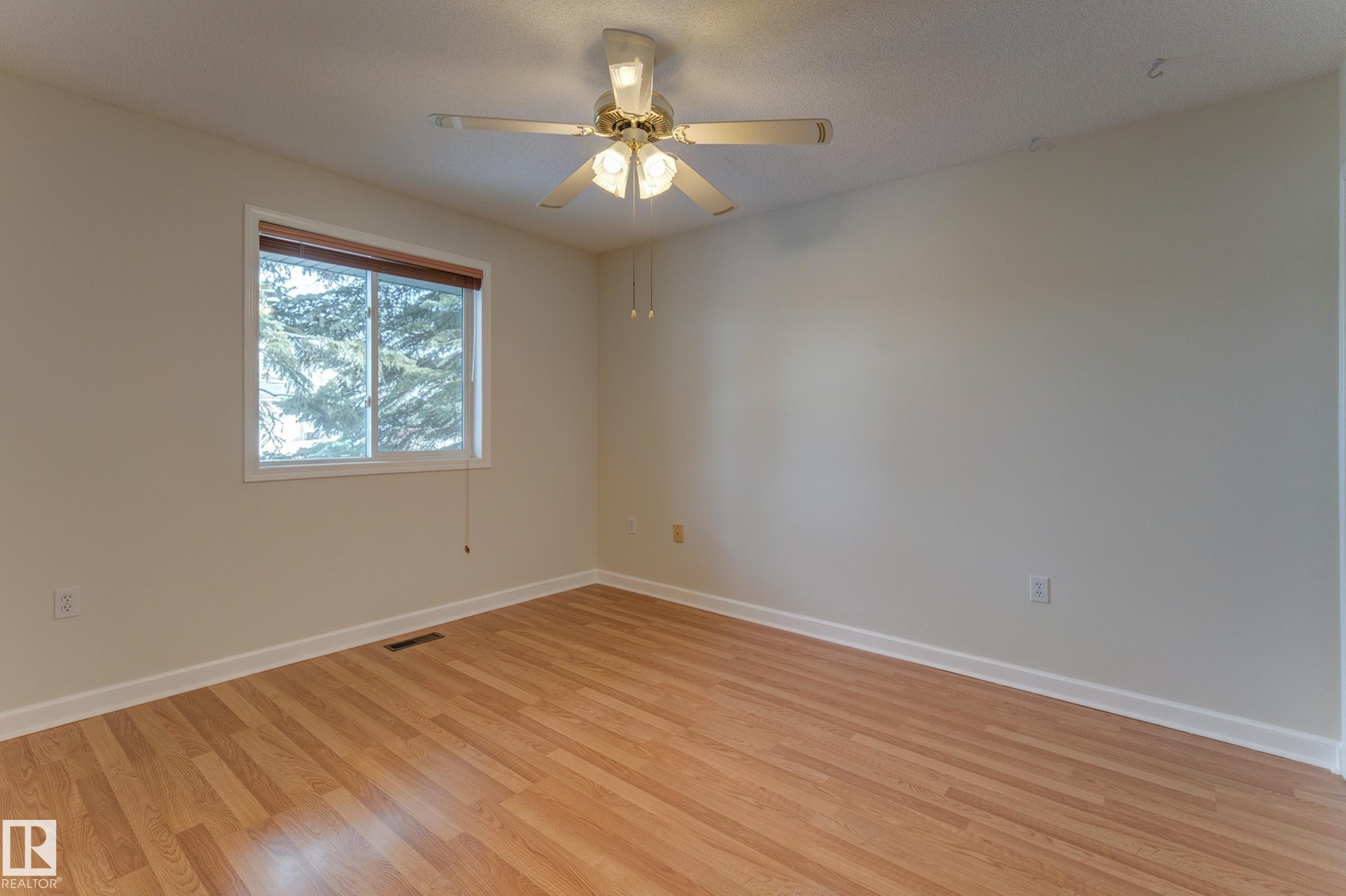 This room features a window with a view of greenery, and a ceiling fan with integrated lighting - 5 308 Jackson Road, Edmonton, AB - Indoor Photo Showing Other Room