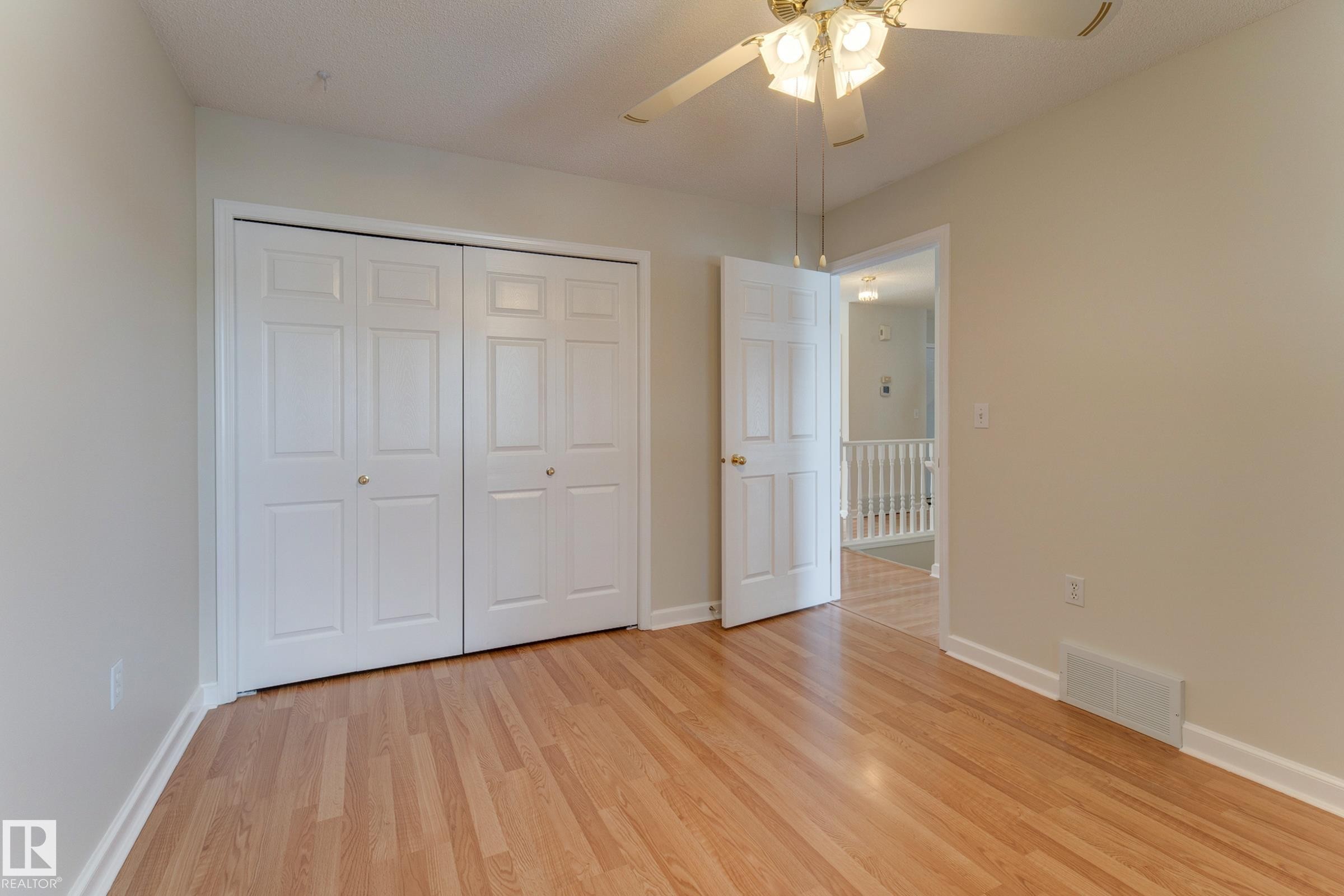 This room features light-colored walls, and white bi-fold closet doors - 5 308 Jackson Road, Edmonton, AB - Indoor Photo Showing Other Room