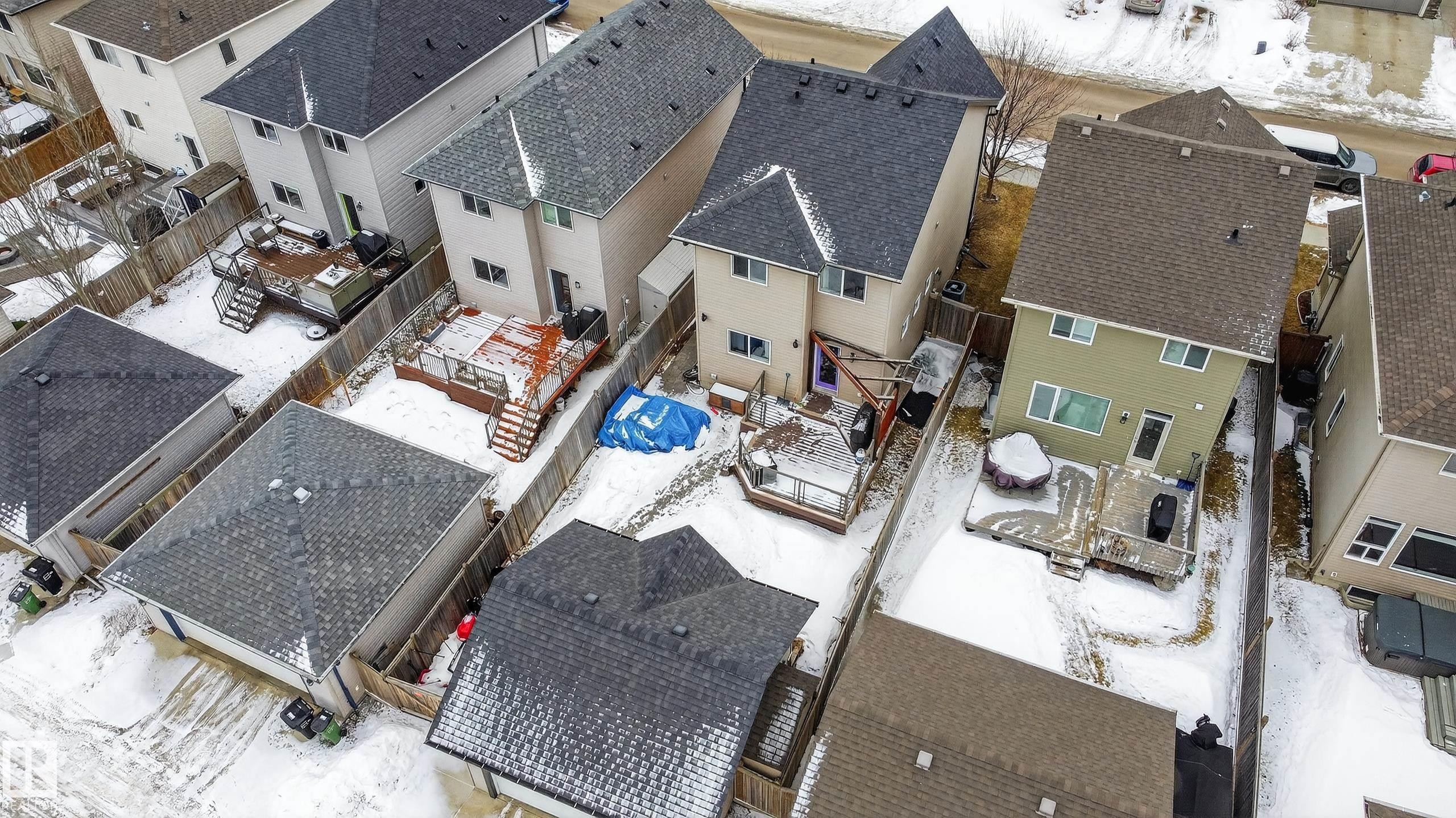 The property features a fenced yard with a deck and a detached garage, offering practical outdoor space - 1522 Chapman Way, Edmonton, AB - Outdoor