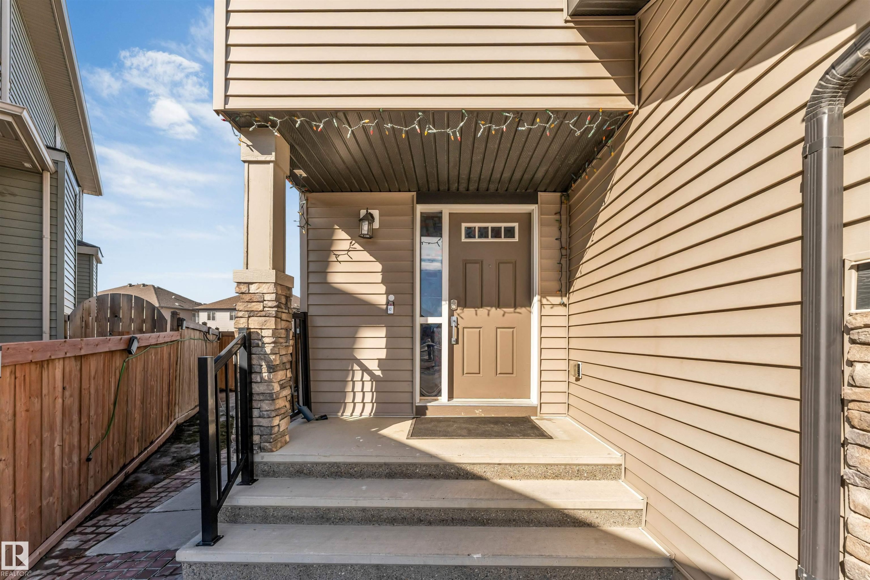 The property features a welcoming front entrance with concrete steps and a covered porch - 2244 21 Avenue, Edmonton, AB - Outdoor With Exterior