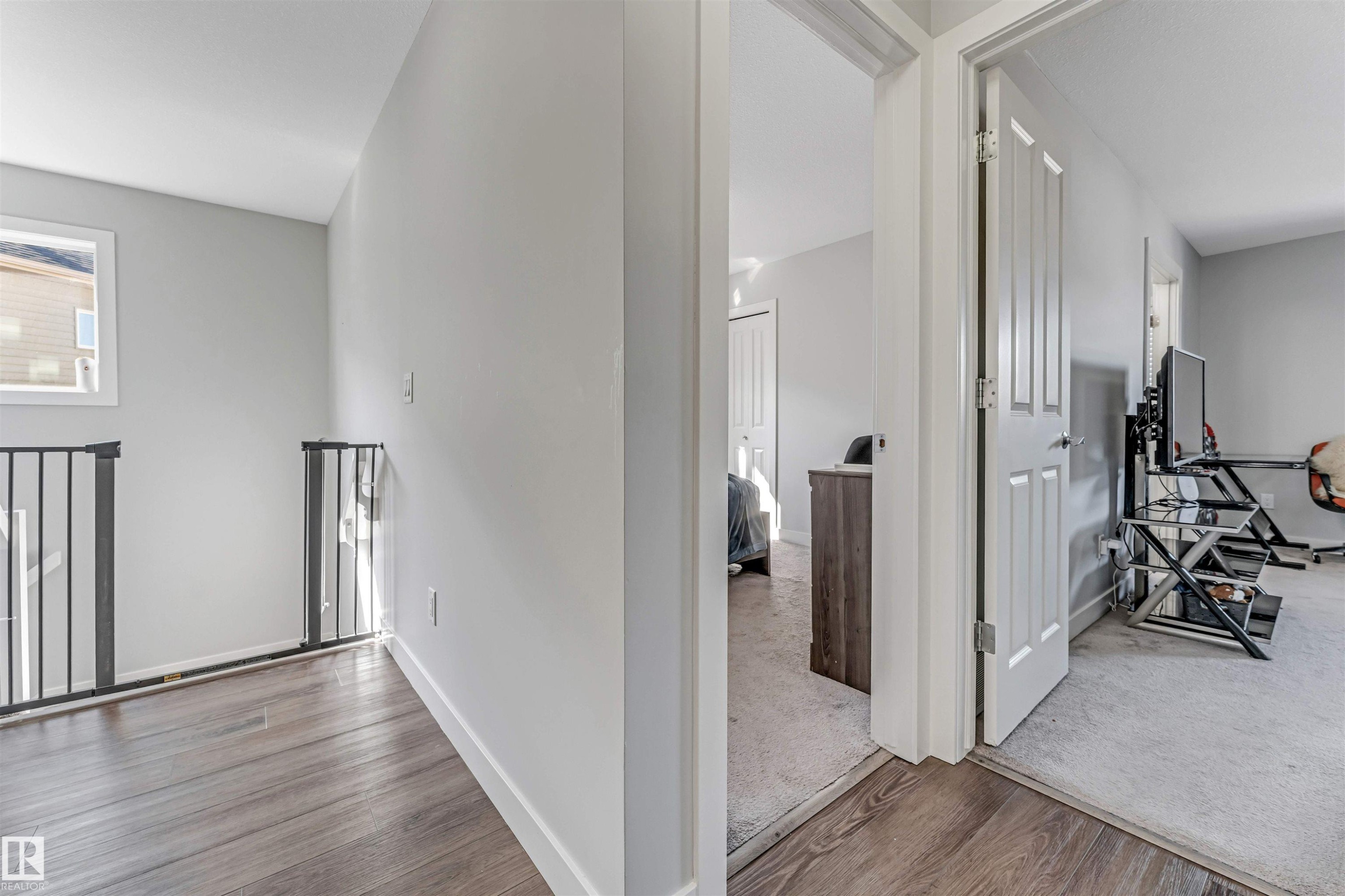 This property features light gray walls, dark wood flooring, and white trim - 2244 21 Avenue, Edmonton, AB - Indoor Photo Showing Other Room