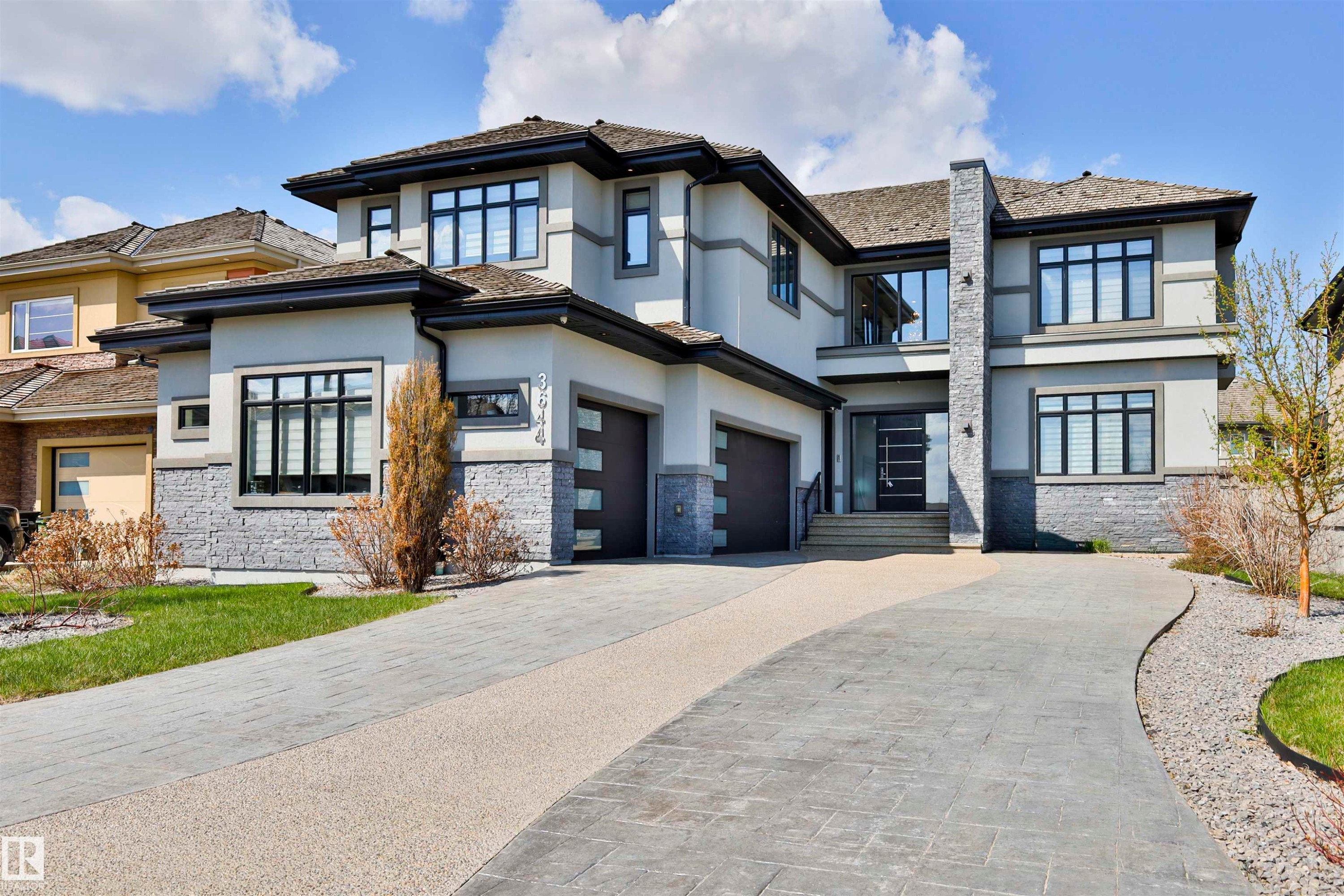 Modern home exterior featuring multiple gables, stone accents, and a multi-level roofline - 3644 Westcliff Way, Edmonton, AB - Outdoor With Facade