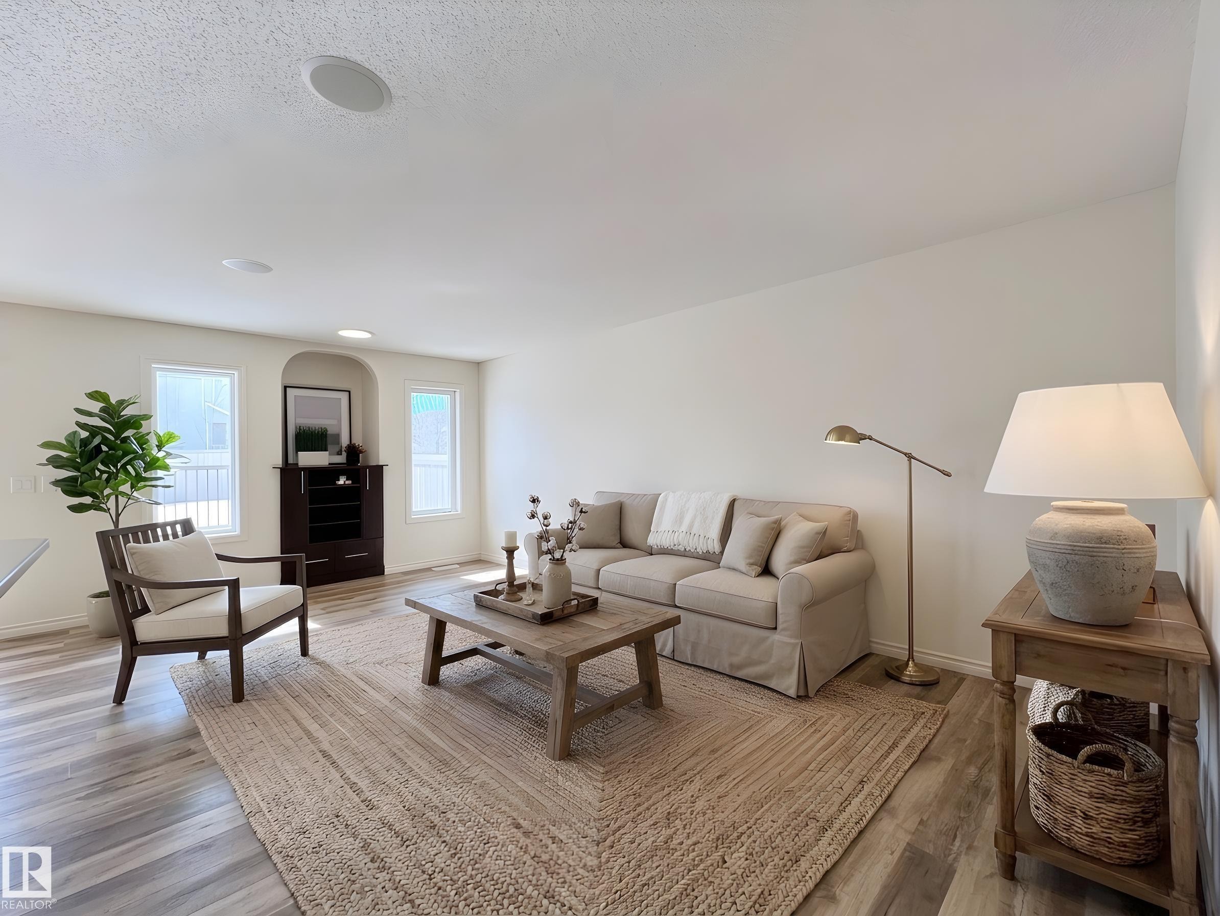 The living room features light-colored walls and flooring, with visible recessed lighting - 17127 7A Avenue, Edmonton, AB - Indoor Photo Showing Living Room
