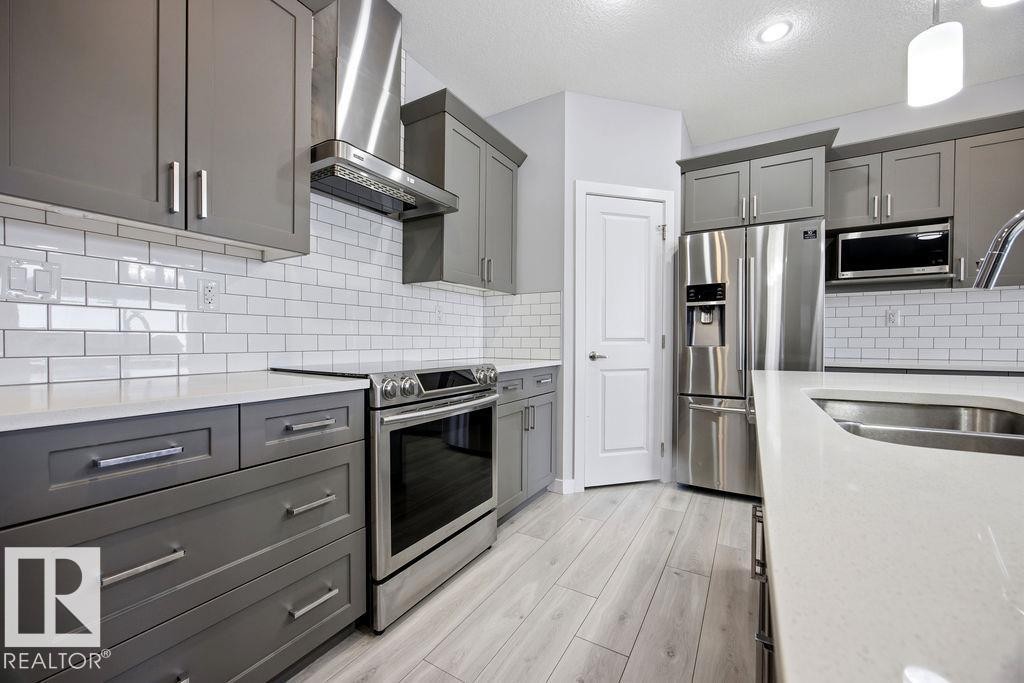 1057 Coopers Hawk Link, Edmonton, AB - Indoor Photo Showing Kitchen With Stainless Steel Kitchen With Double Sink With Upgraded Kitchen