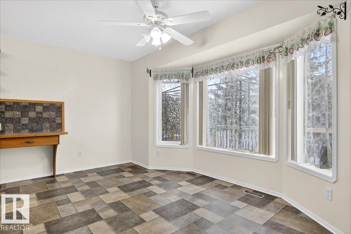 This bright room features a bay window, a ceiling fan, and tiled flooring - 4412 Yeoman Close, Onoway, AB - Indoor Photo Showing Other Room