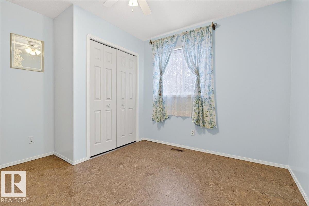 This room features light blue walls, a window with curtains, and a ceiling fan - 4412 Yeoman Close, Onoway, AB - Indoor Photo Showing Other Room