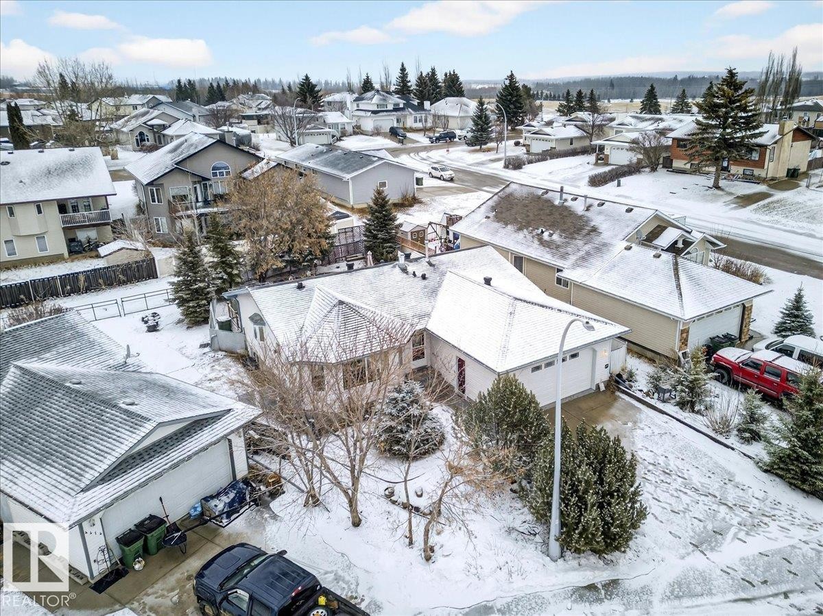 The property features a white exterior, an attached garage, and a driveway - 4412 Yeoman Close, Onoway, AB - Outdoor