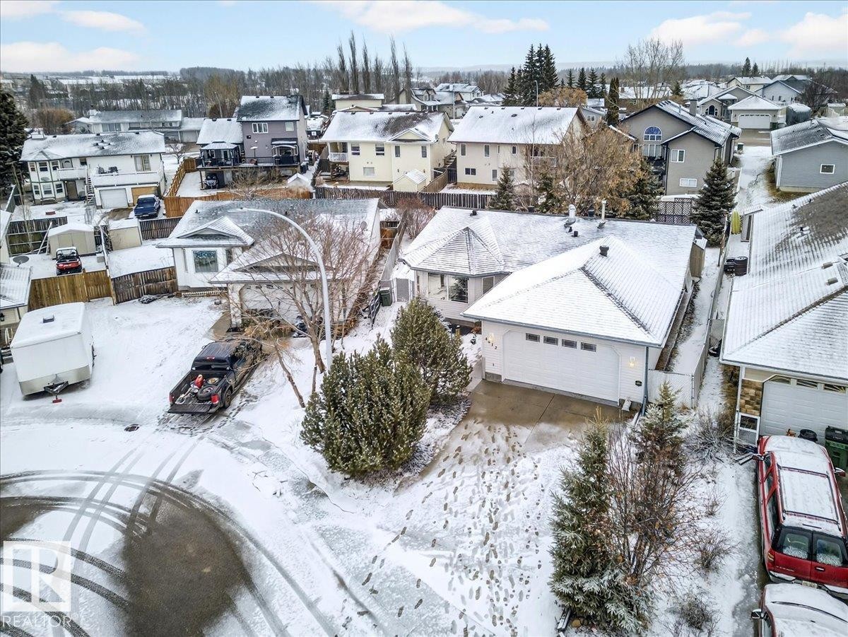 The property features a white exterior, a two-car garage, and a paved driveway - 4412 Yeoman Close, Onoway, AB - Outdoor