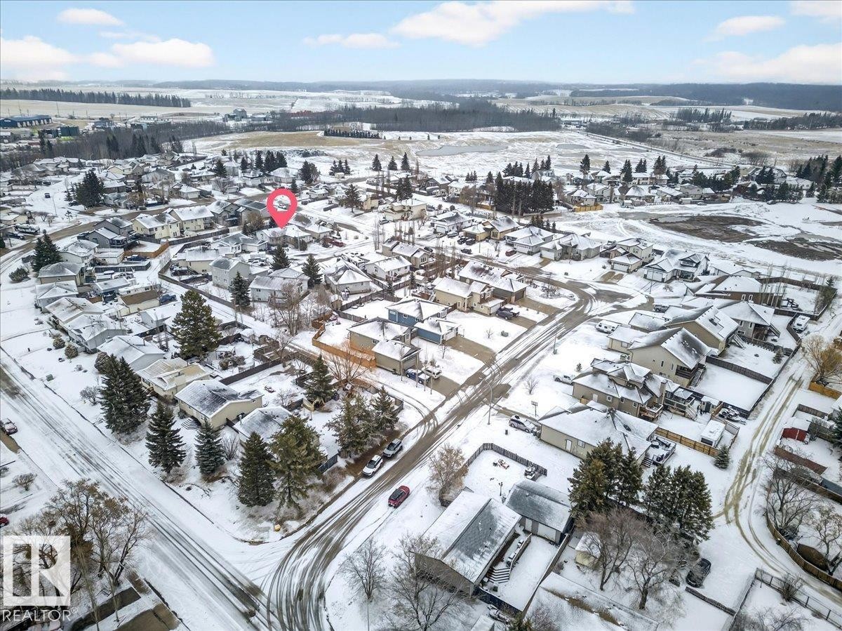 Aerial view of the property and surrounding neighborhood, featuring a residential area with snow-covered streets and rooftops - 4412 Yeoman Close, Onoway, AB - Outdoor With View