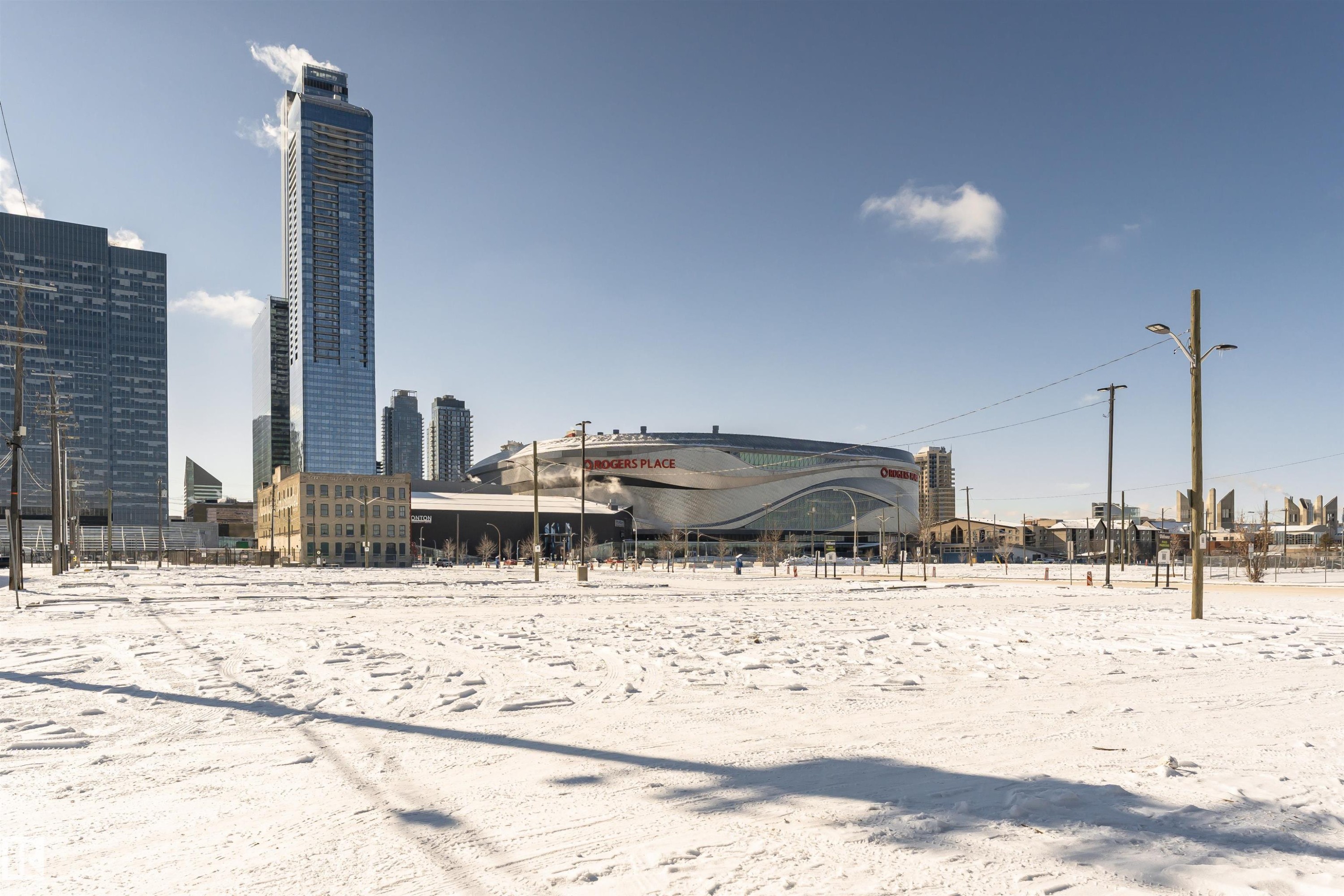 The property offers views of an urban skyline featuring prominent skyscrapers and a large, modern arena - 107 10118 106 Avenue, Edmonton, AB - Outdoor With View