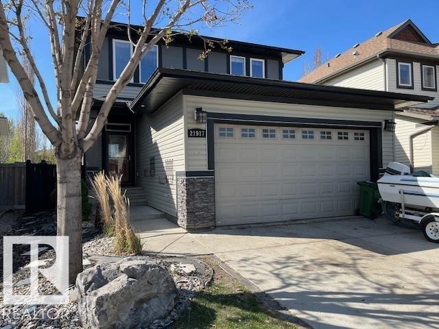 Contemporary two-story residence featuring light gray siding with dark gray accents and stone detailing - 21917 95A Avenue, Edmonton, AB - Outdoor