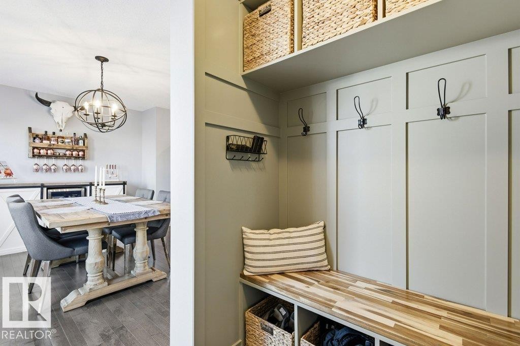 The property features a well-appointed mudroom with a built-in bench, hooks, and overhead shelving, providing practical storage solutions - 16720 15 Avenue, Edmonton, AB - Indoor