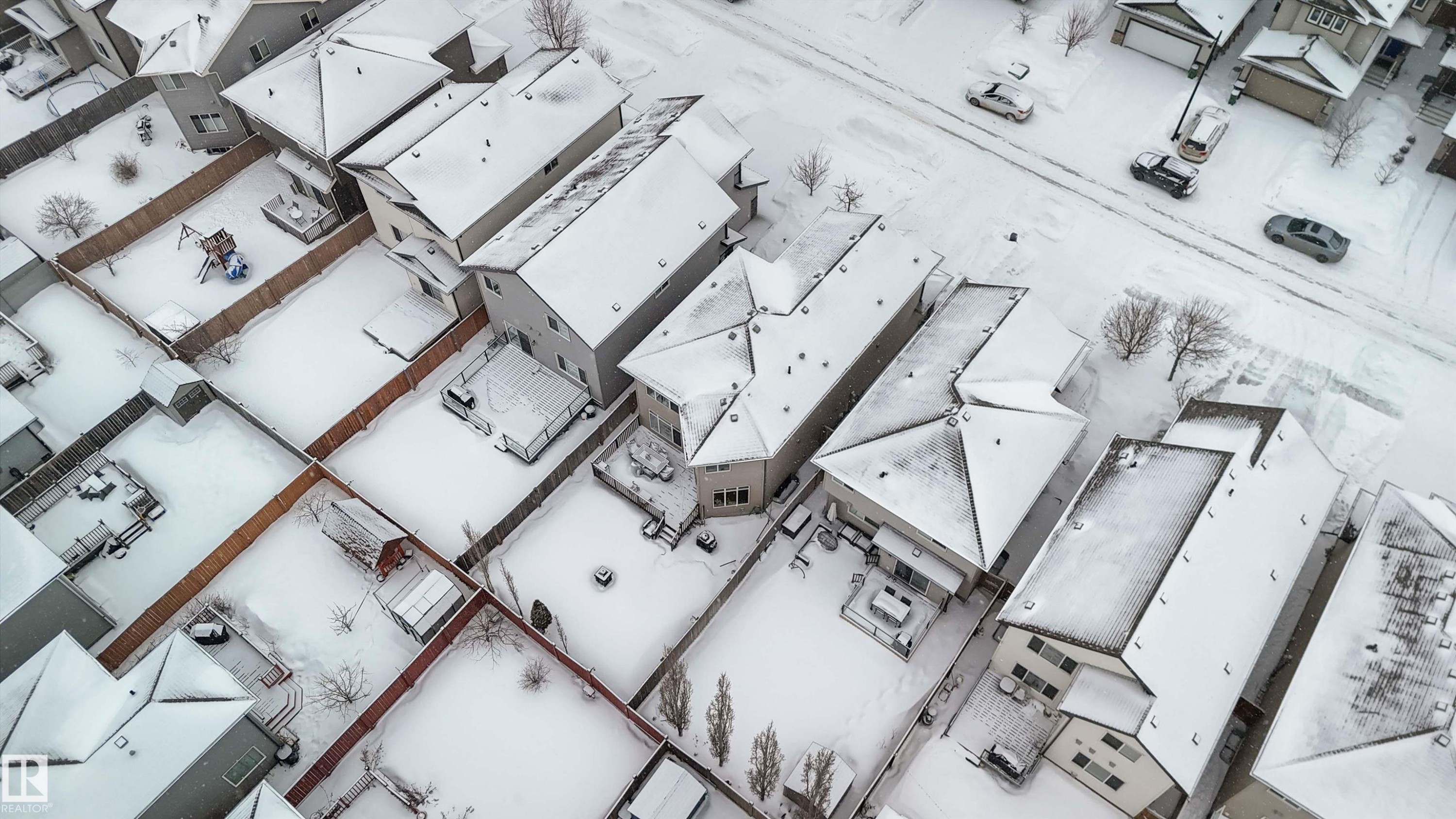 Aerial view of the neighborhood showcasing several properties with snow-covered roofs and yards, and a street with parked vehicles - 12232 167B Avenue, Edmonton, AB - Other