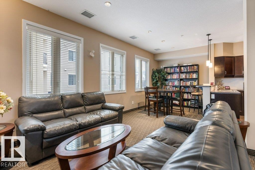 206 6083 Maynard Way, Edmonton, AB - Indoor Photo Showing Living Room