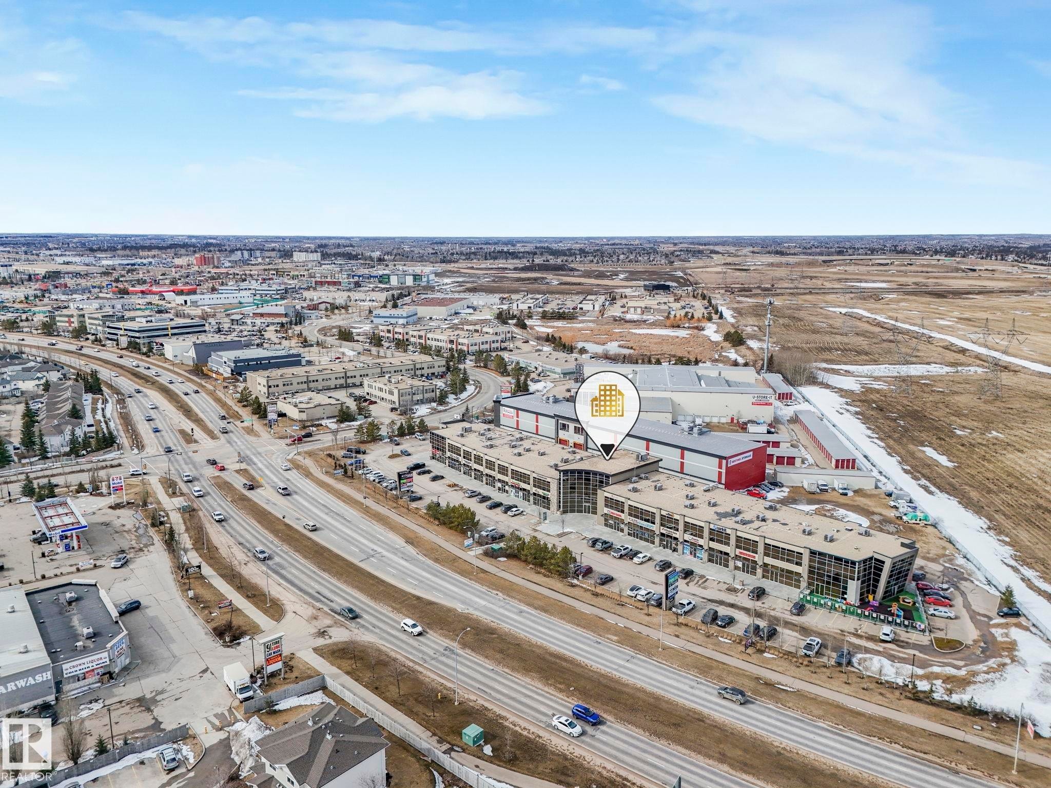 Aerial view showcasing the property's advantageous location near a major roadway, providing convenient transportation access - 123 230 Edwards Drive, Edmonton, AB - Outdoor With View