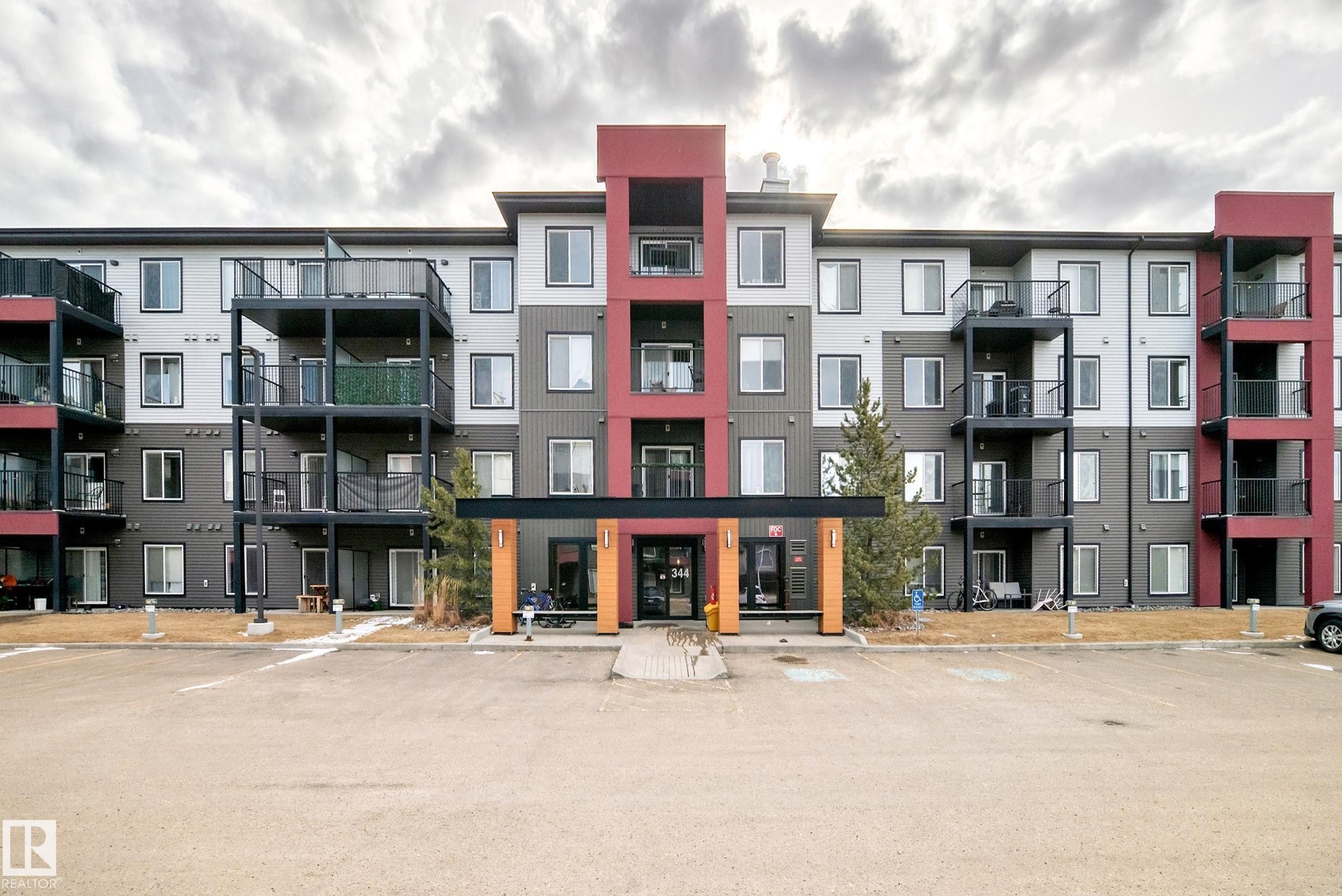 The building features a modern exterior with a multi-level design, individual balconies, and a distinct entry canopy - 332 344 Windermere Road, Edmonton, AB - Outdoor With Balcony With Facade