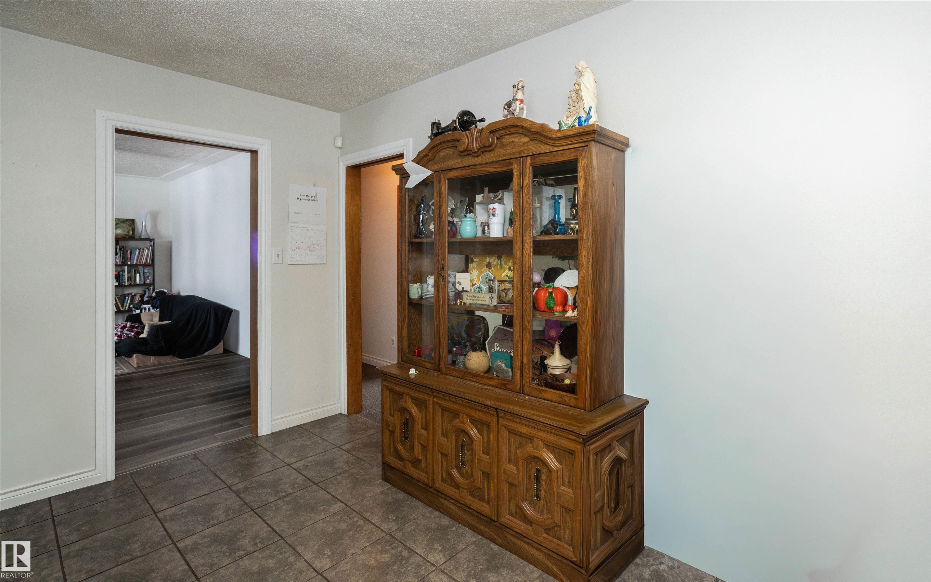 The property features tiled flooring in this area, with white baseboards and walls - 4420 56 Avenue, Barrhead, AB - Indoor Photo Showing Other Room
