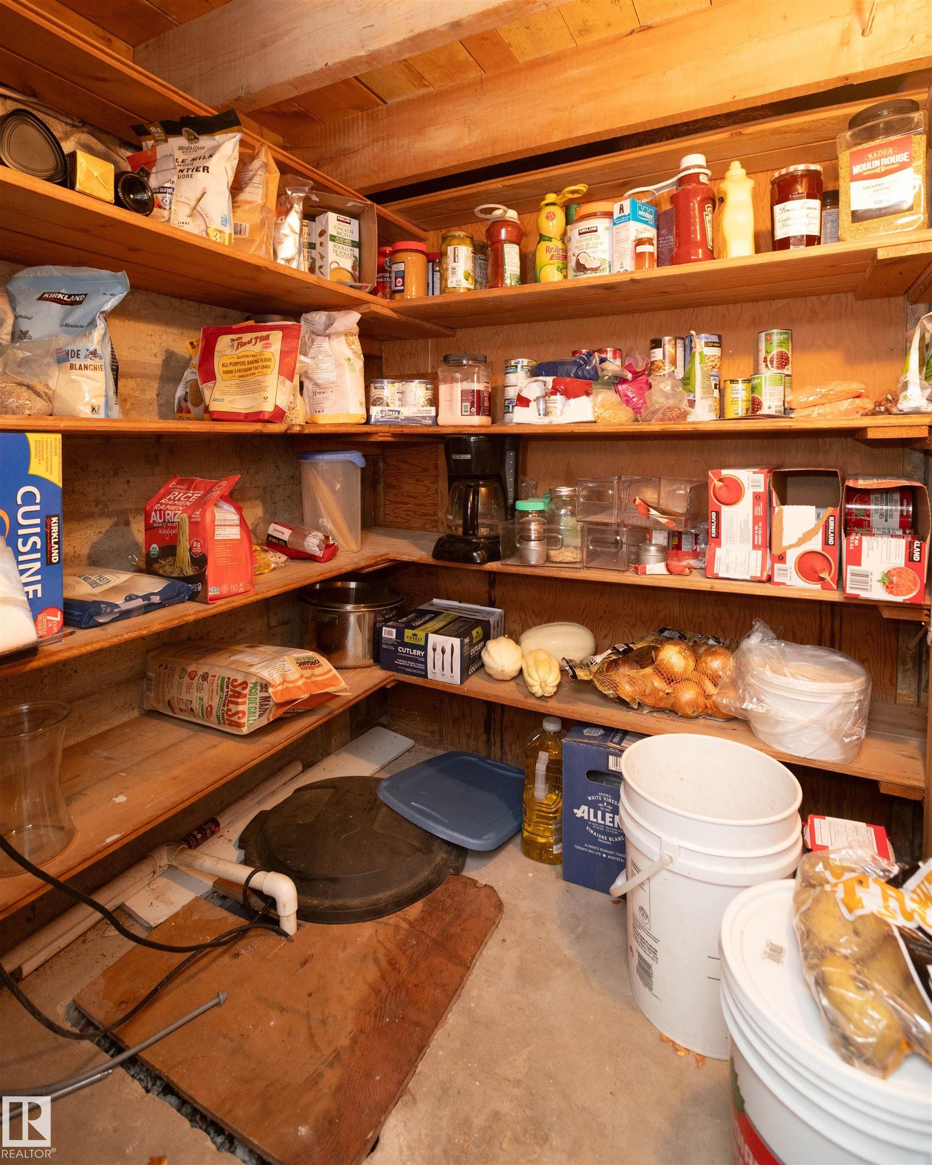This dedicated storage area features extensive wooden shelving units for organization - 4420 56 Avenue, Barrhead, AB - Indoor