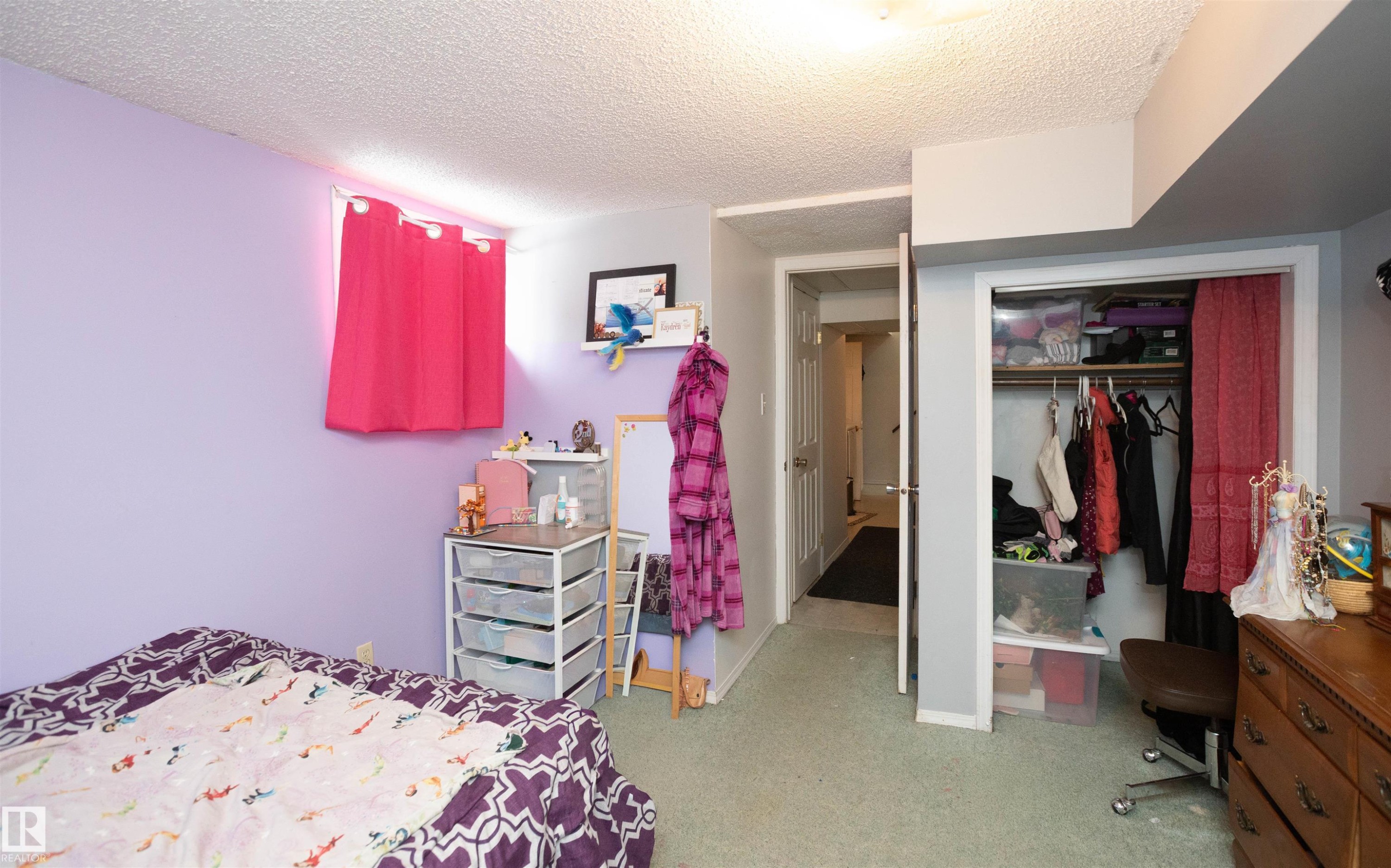 This room features purple walls, a window with pink curtains, and carpeted flooring - 4420 56 Avenue, Barrhead, AB - Indoor Photo Showing Bedroom