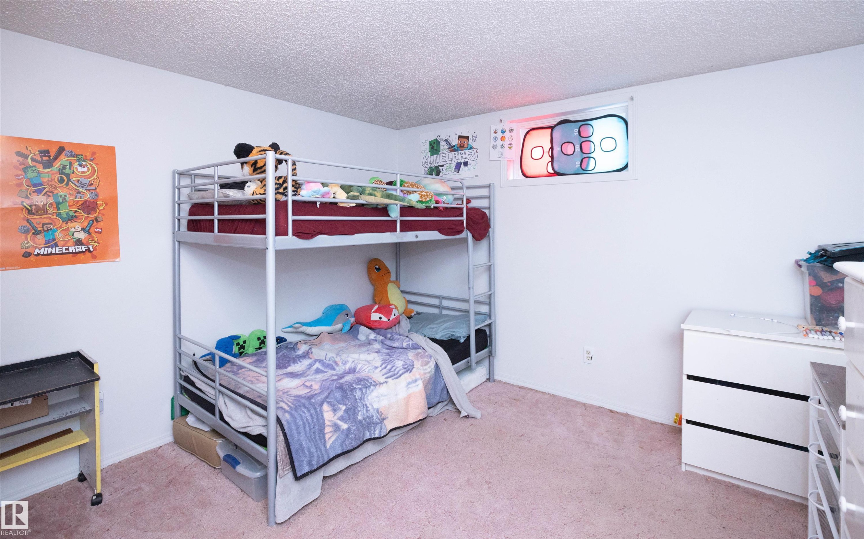 This room features white walls, a textured ceiling, and soft pink carpeting - 4420 56 Avenue, Barrhead, AB - Indoor Photo Showing Bedroom