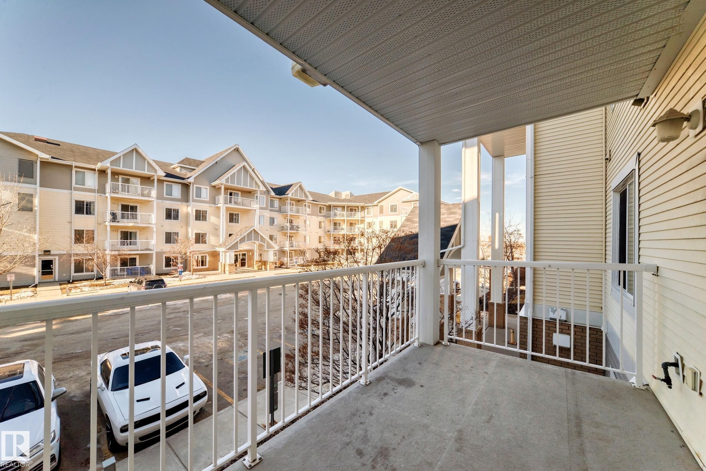The property features a private balcony with a concrete floor and a white railing - 208 2204 44 Ave, Edmonton, AB - Outdoor With Balcony With Exterior
