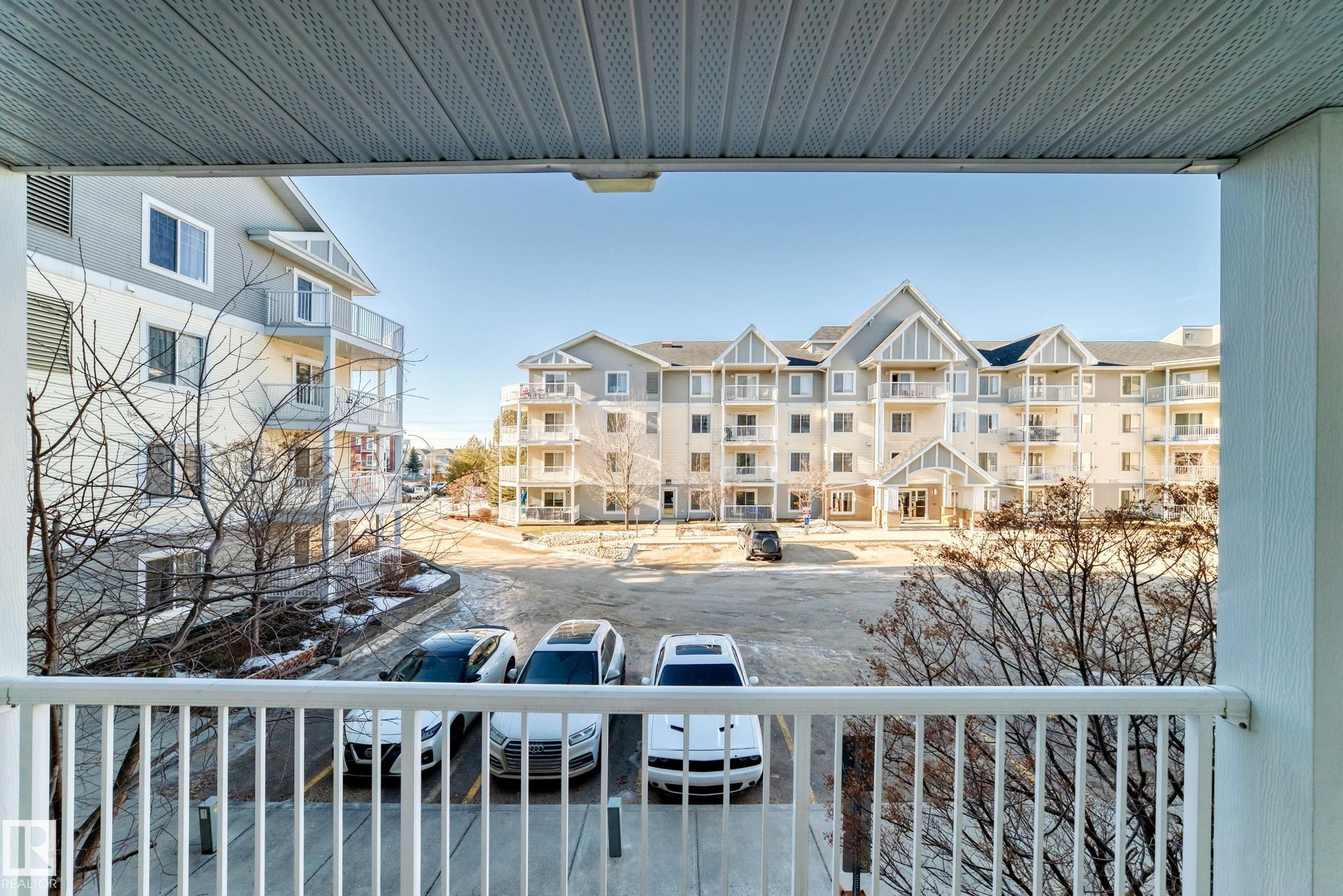 View from the property's balcony, featuring white railings and a textured ceiling - 208 2204 44 Ave, Edmonton, AB - Outdoor With Balcony