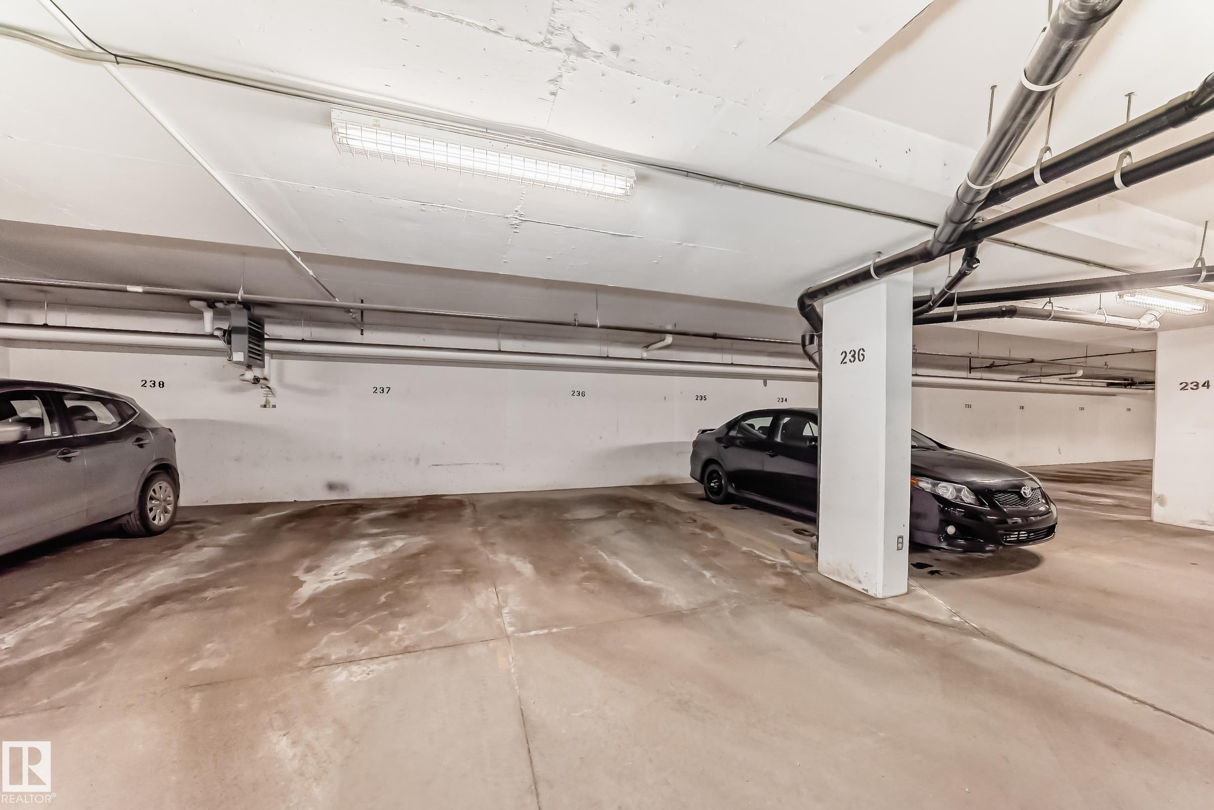 Dedicated parking space with concrete flooring - 208 2204 44 Ave, Edmonton, AB - Indoor Photo Showing Garage