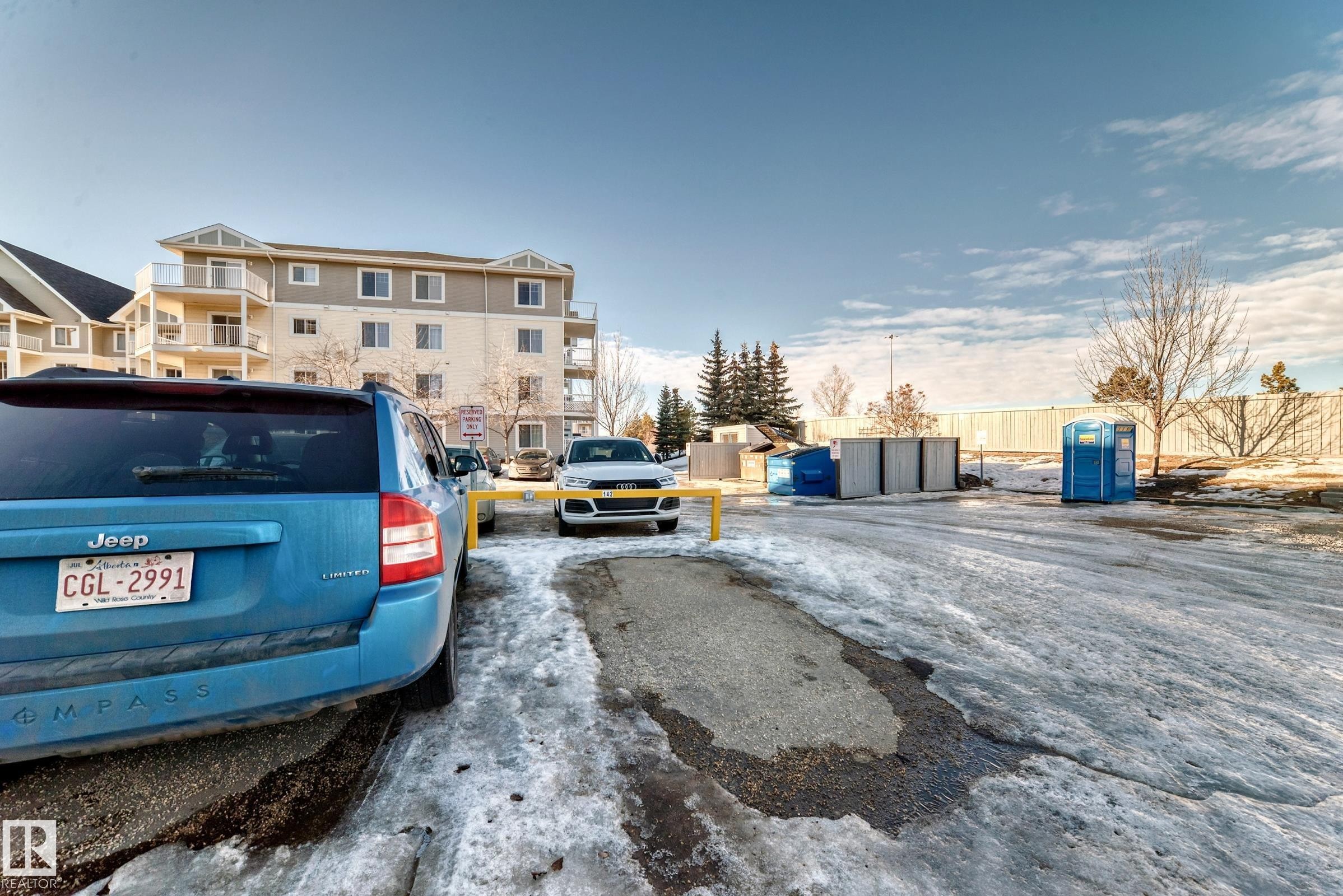 The property features a multi-story building with balconies, visible from a paved outdoor area - 208 2204 44 Ave, Edmonton, AB - Outdoor