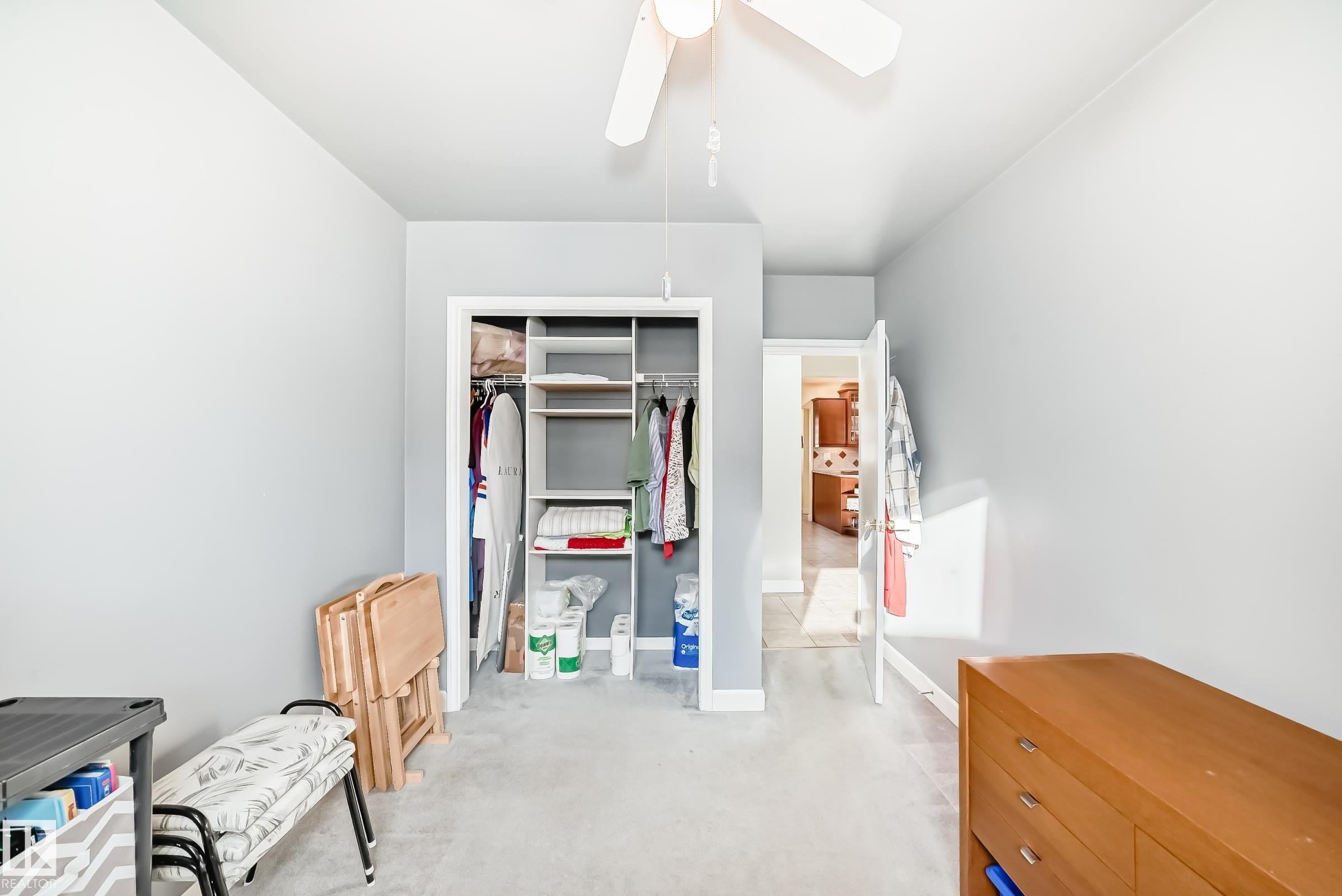 This room features light grey walls and light grey carpeting, creating a neutral palette - 4446 116 Avenue, Edmonton, AB - Indoor