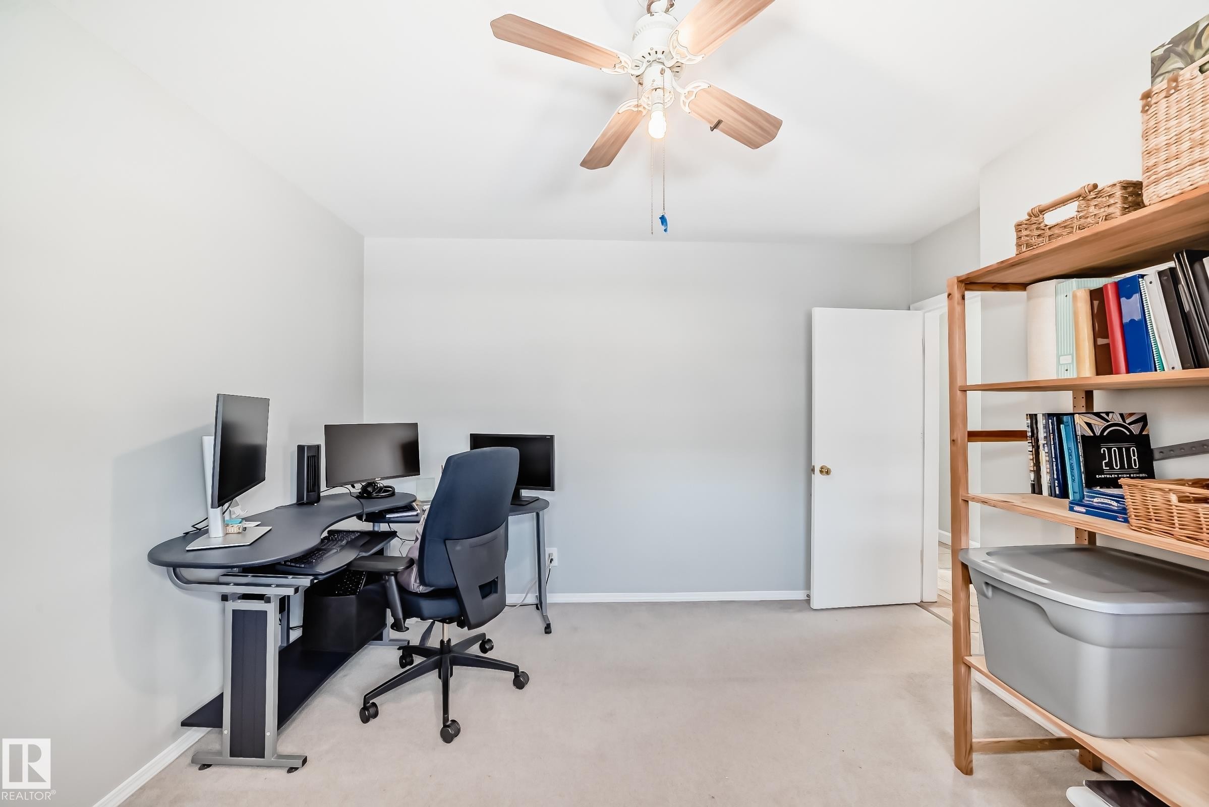 This room features light-colored carpeting, a ceiling fan with a light fixture, and light-colored walls - 4446 116 Avenue, Edmonton, AB - Indoor Photo Showing Office