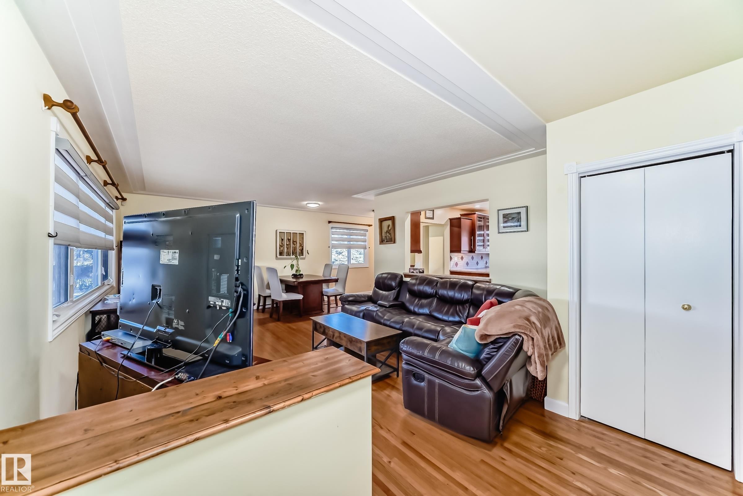 The living area features hardwood floors and a white bi-fold closet - 4446 116 Avenue, Edmonton, AB - Indoor