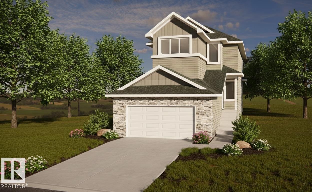 The property features a two-story design with a prominent garage, a paved driveway, and stone accents on the facade - 16 Grayson Green, Stony Plain, AB - Outdoor