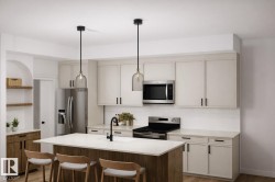 The kitchen features light-colored cabinetry with dark hardware, stainless steel appliances, and a central island with seating -